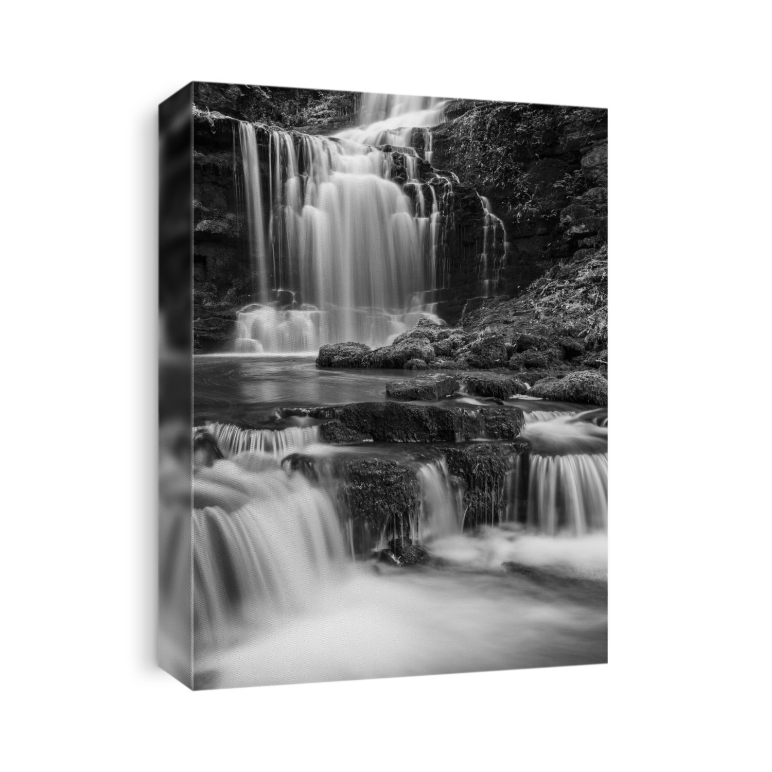 Black and white image of numerous waterfalls flowing over rocks in the Yorkshire Dales; Settle, North Yorkshire, England