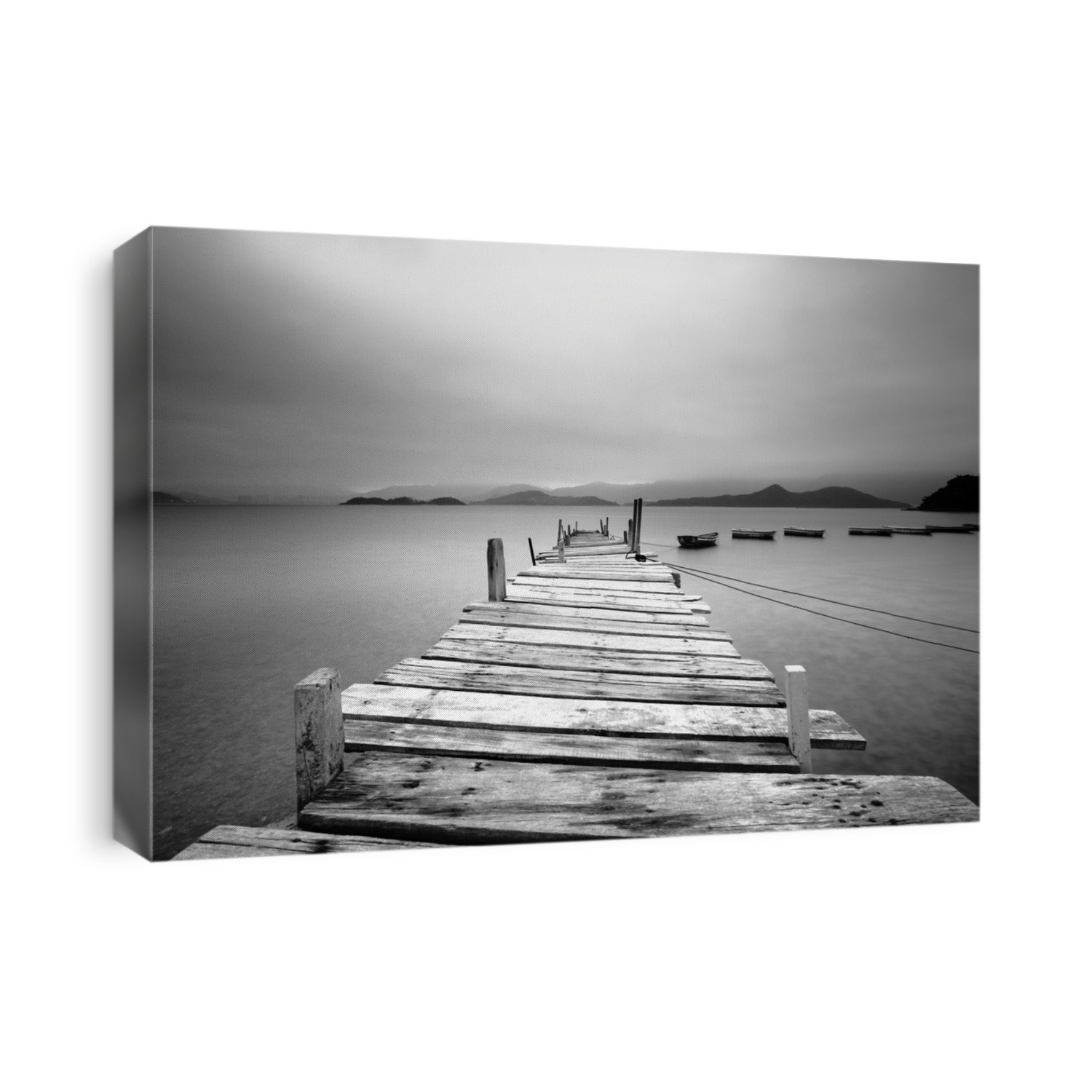 Looking over a pier and boats, black and white