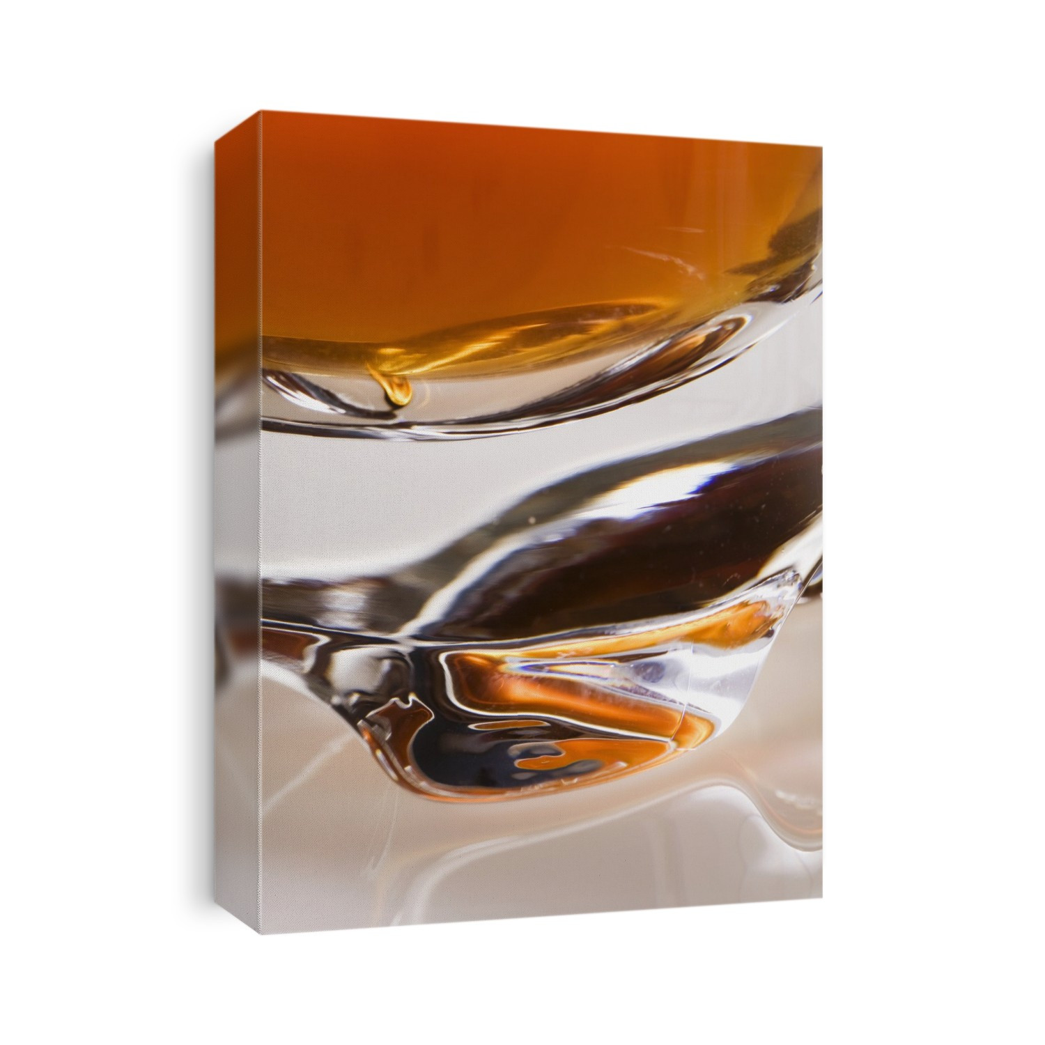 Close-Up Of The Base Of A Glass Filled With An Orange Liquid