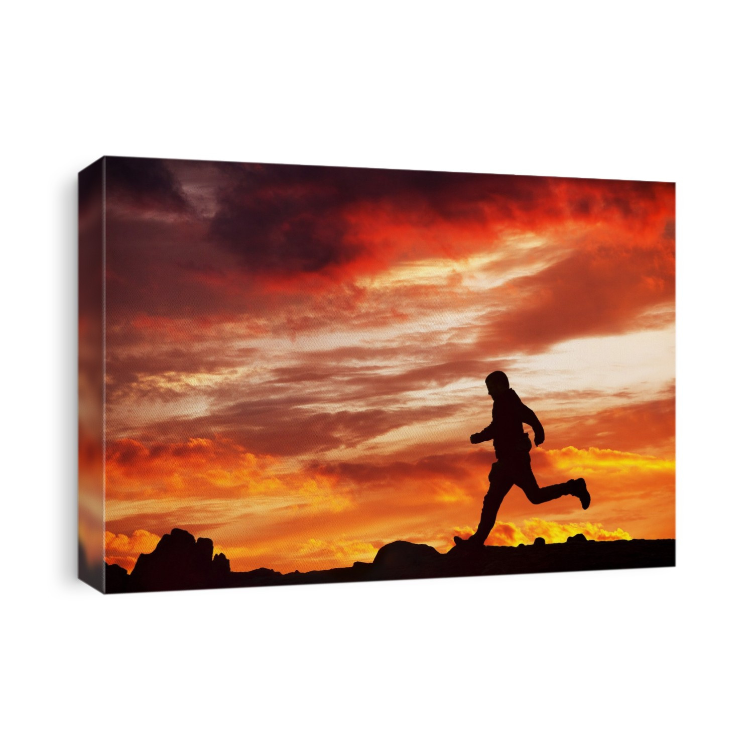 A Man running over Red Screes at sunset, Lake District, UK.