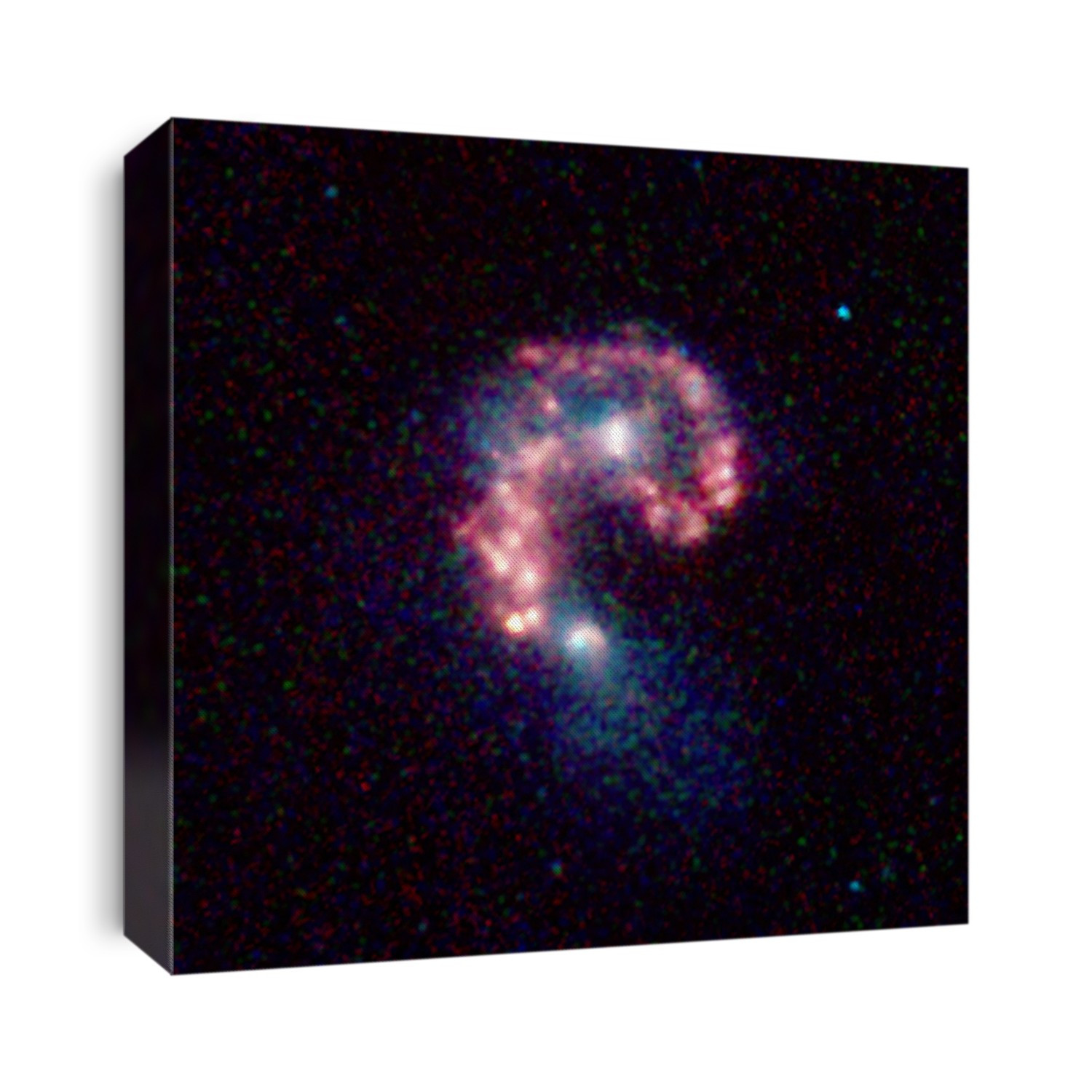 Antennae Galaxies. Spitzer infrared image of the Antennae Galaxies NGC 4038 and NGC 4039, a pair of colliding spiral galaxies. They are found in the constellation of Corvus at a distance of about 60 million light years and have been merging together for the past 800 million years. The bright (white) areas seen here are associated with regions of stellar formation which was triggered by the collision between the two galaxies. Image taken by the Spitzer Space Telescope.