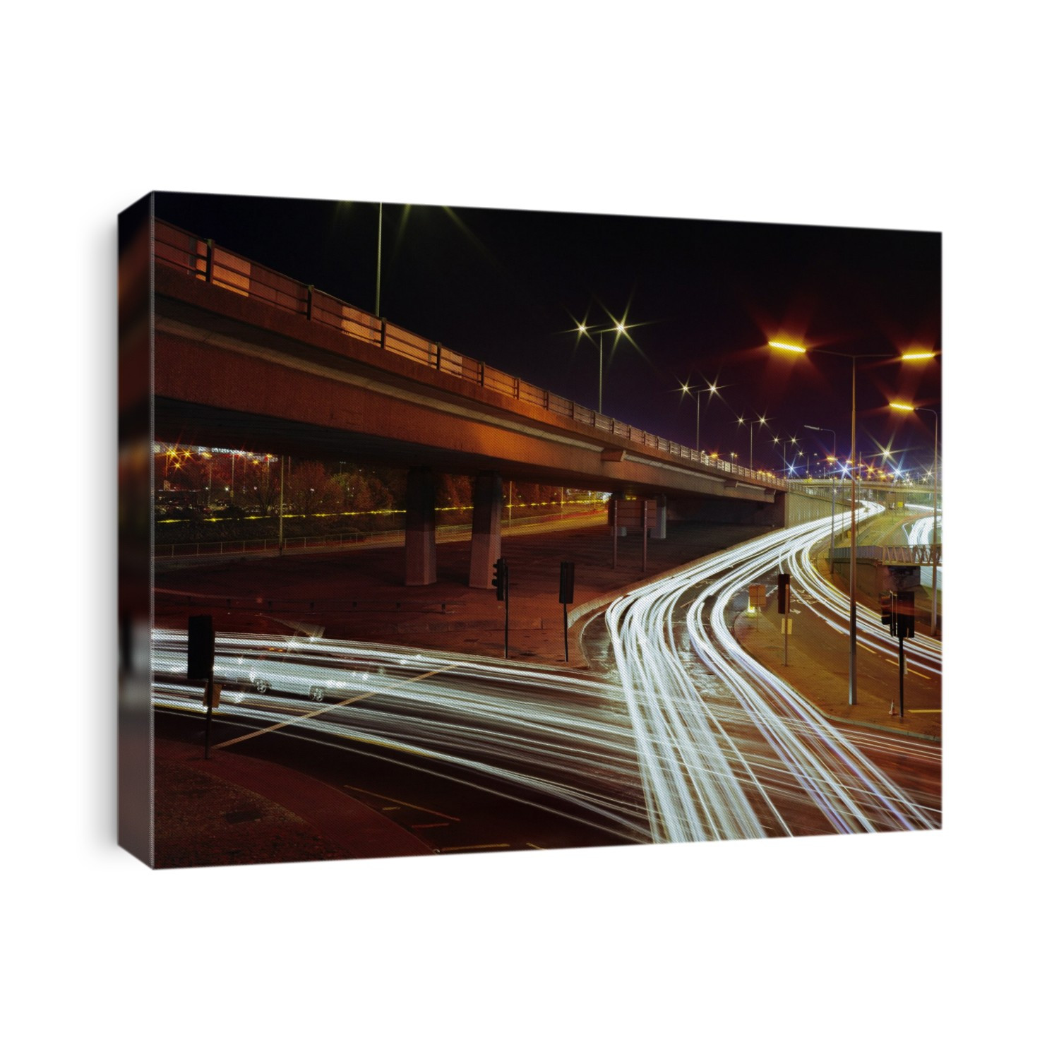 Traffic at night. Time-exposure of vehicles travelling on a trunk road interchange.