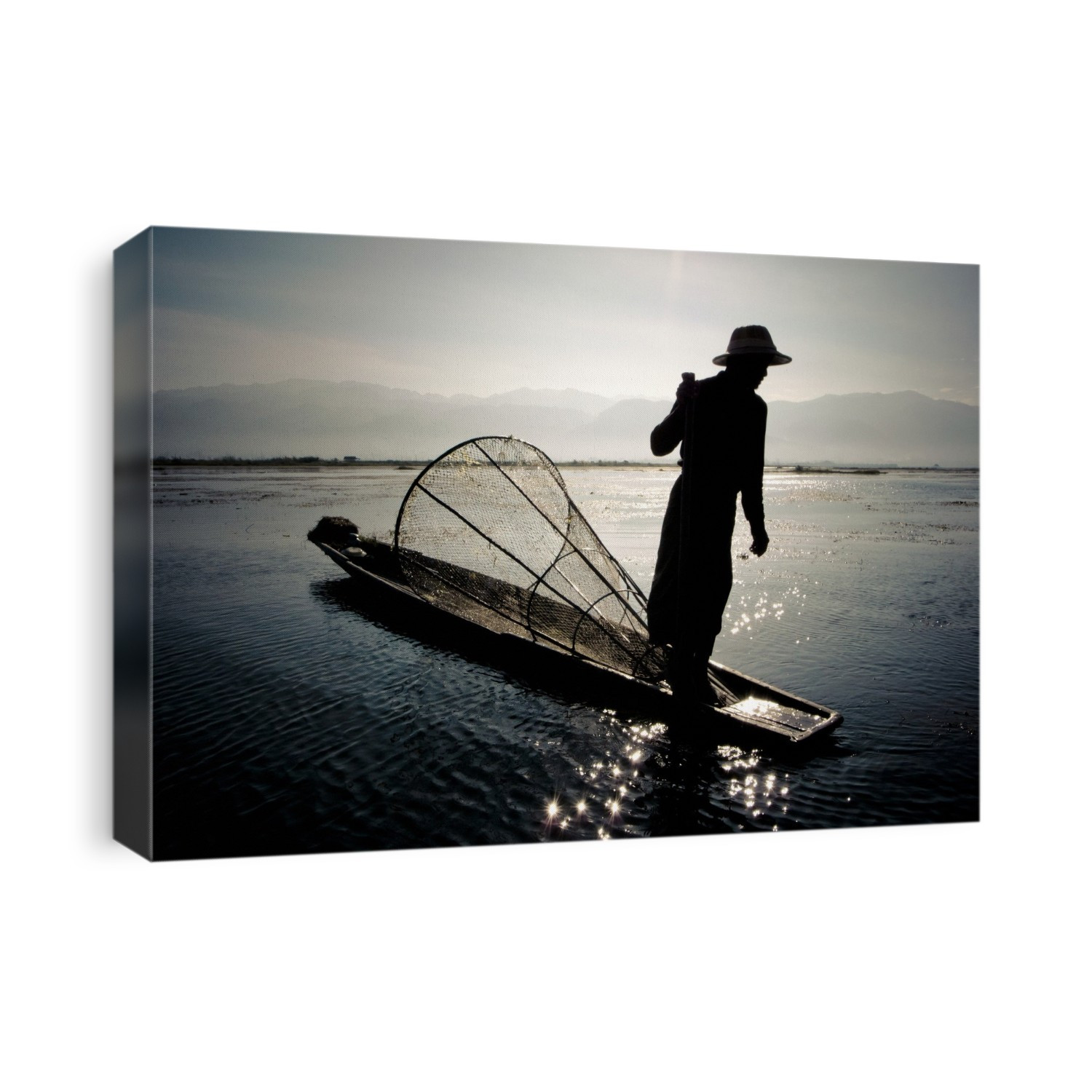 Traditional Burmese fishing boat and fisherman. Photographed on Inle Lake, Burma.