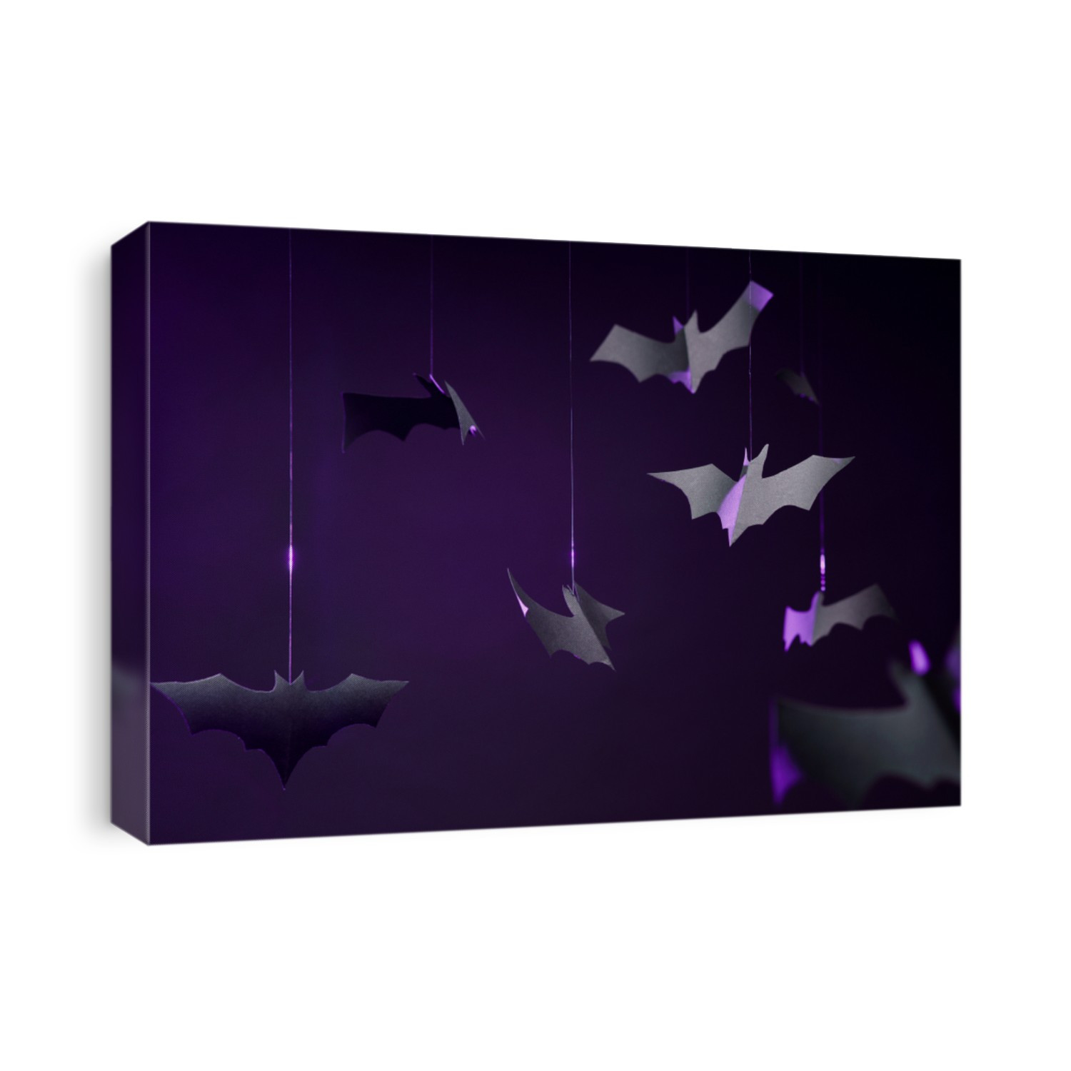 Photo of gray paper bats on empty purple background.