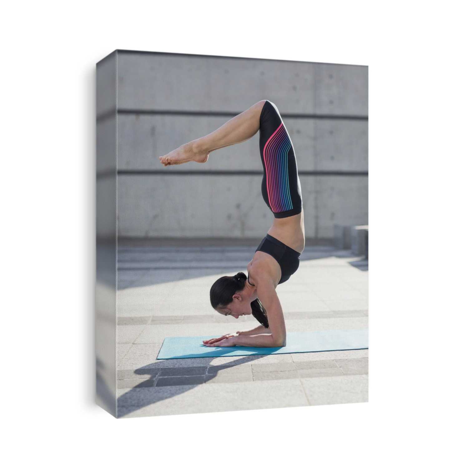 Young woman balancing on arms in yoga position.