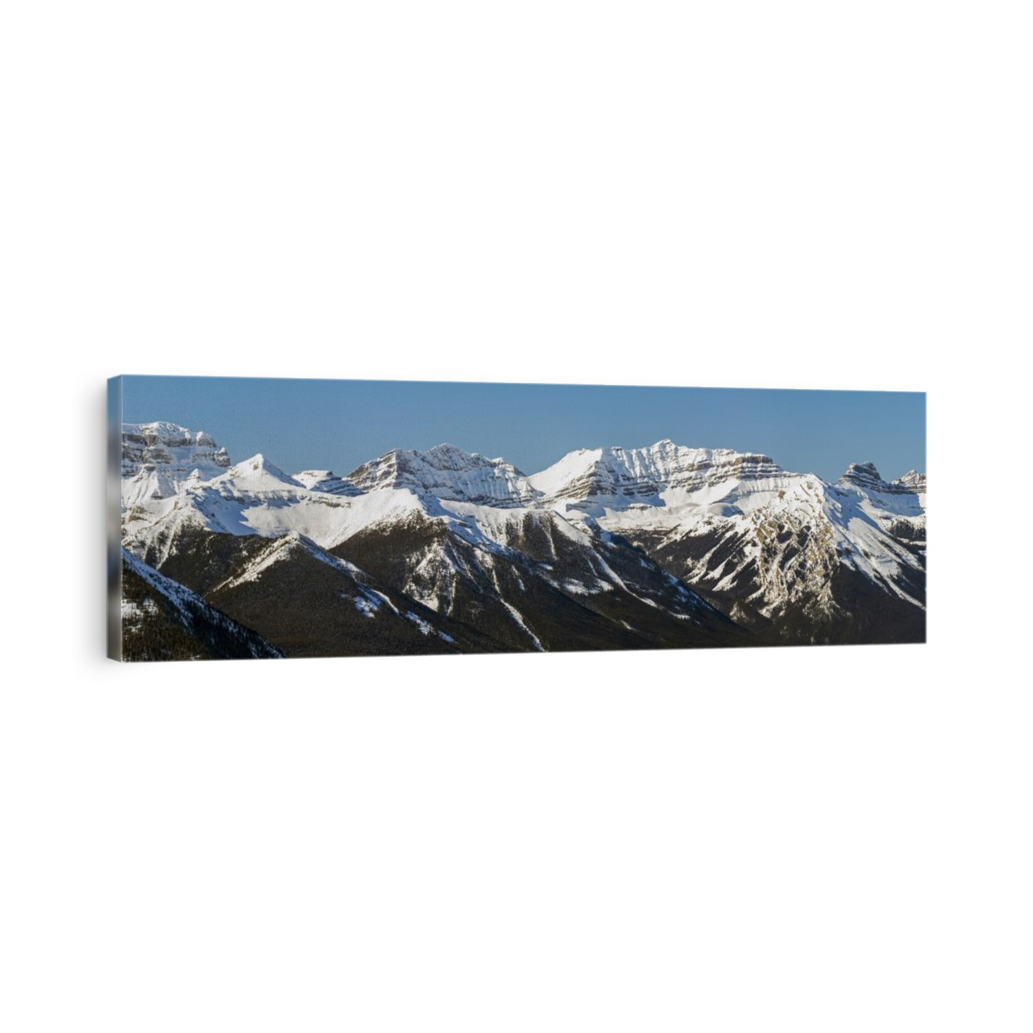 Panorama of snow-covered mountain range and blue sky; Banff, Alberta, Canada