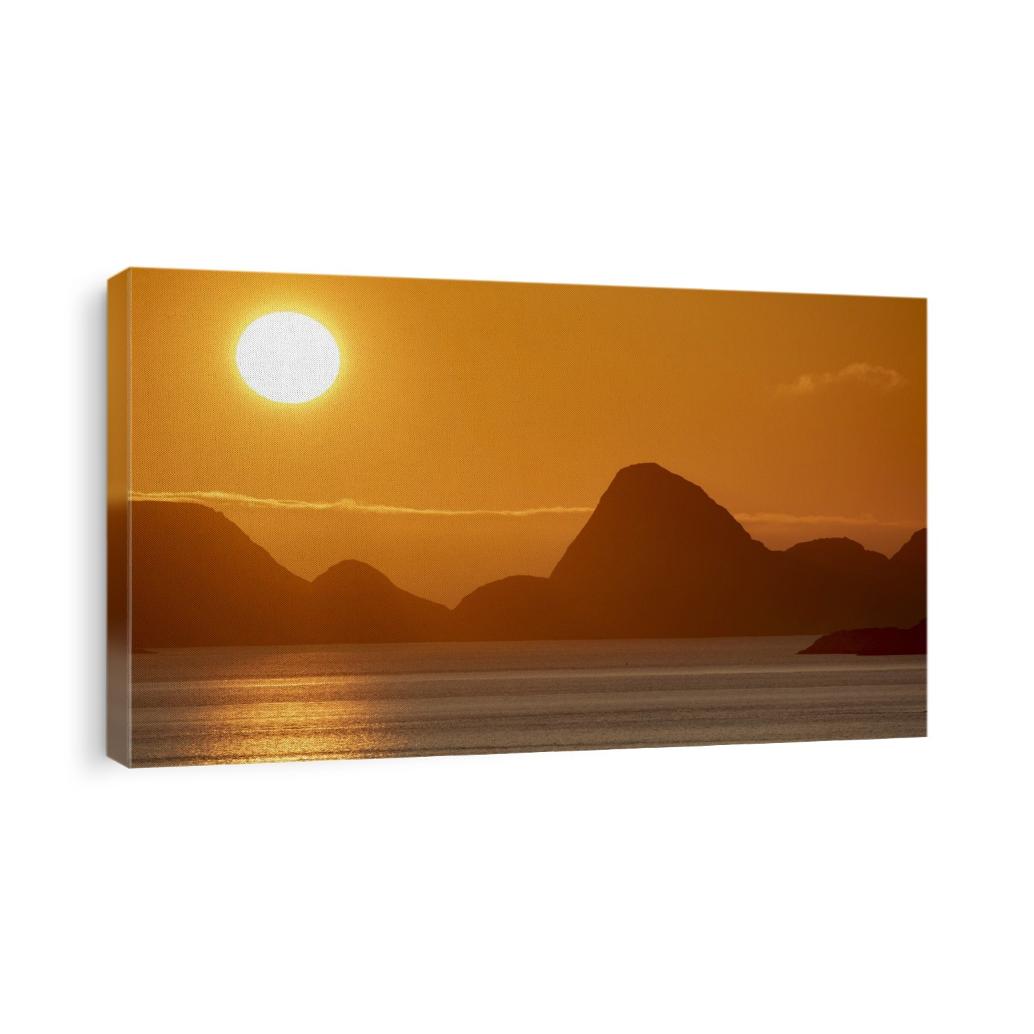 Midnight Sun glowing brightly in the orange sky over the mountain peaks and reflecting on the North Atlantic Ocean; Lofoten, Arctic Circle, Norway