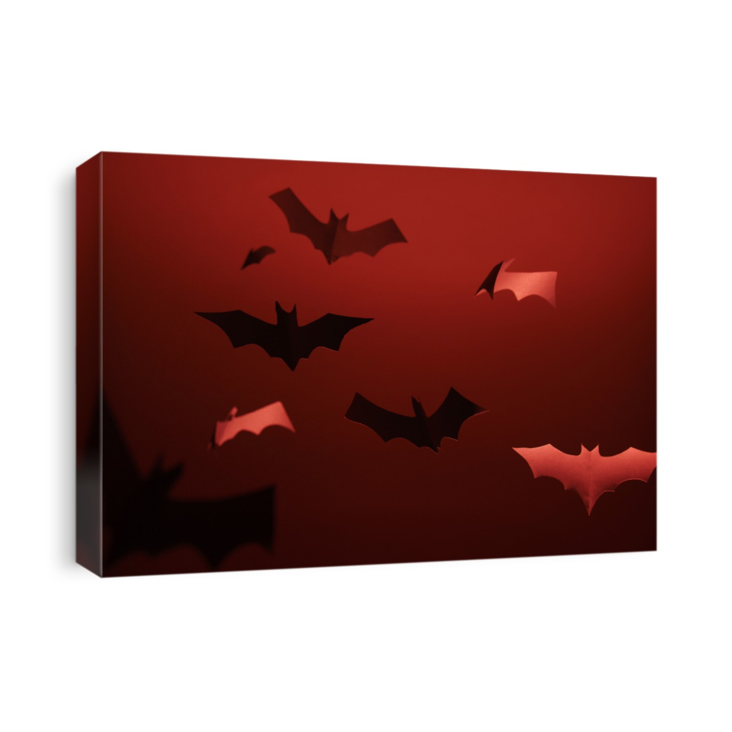 Image of gray paper bats on blank red background.