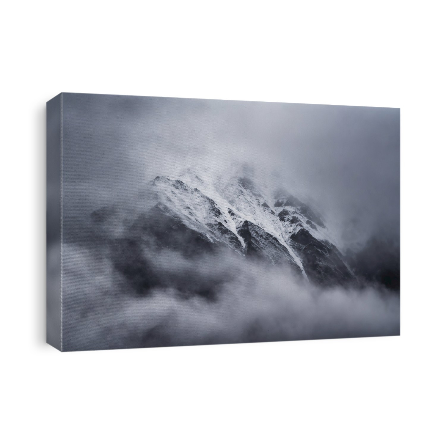 Rocky mountain peaks emerge through the misty clouds at Kluane National Park; Yukon, Canada