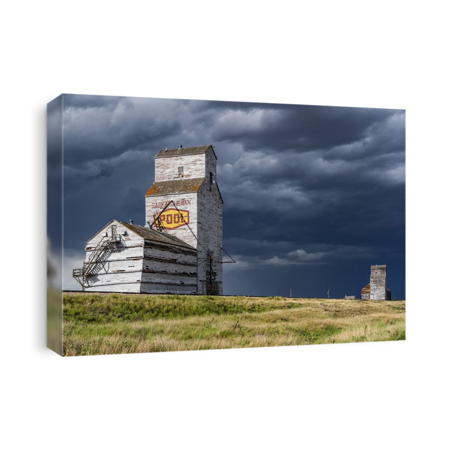 Weathered grain elevator and storm on the prairies; Saskatchewan, Canada