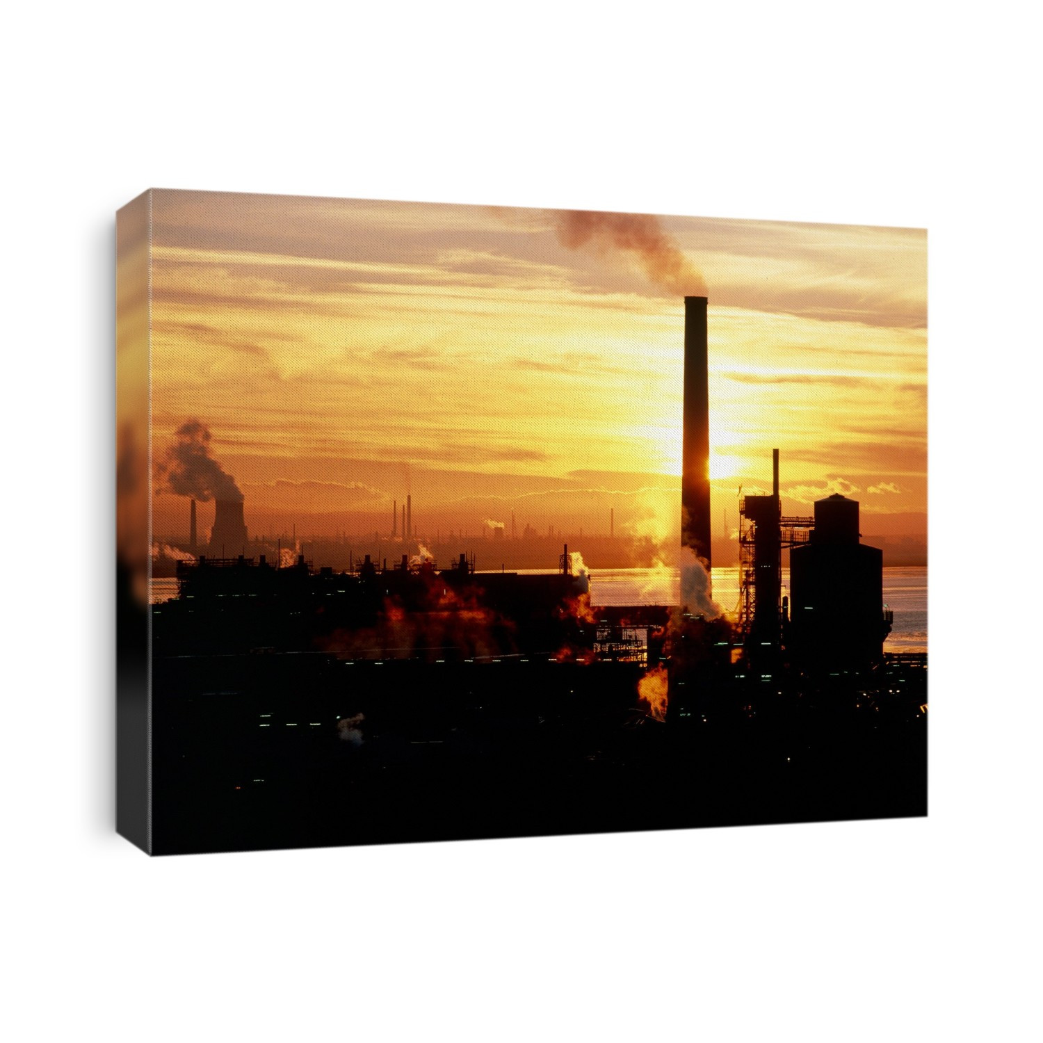 Sunset over ICI's Castner Kellner chemical plant in Runcorn, Cheshire, UK. In the background are the river Mersey and Ellesmere Port.