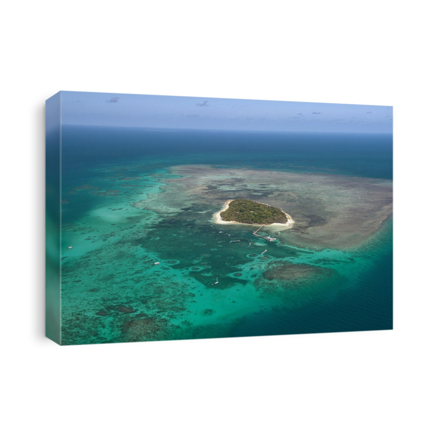 Green Island, Great Barrier Reef. Aerial photograph of Green Island on the Great Barrier Reef in the Coral Sea, near Cairns, Australia. Part of Green Island National Park, this site is a popular tourist destination. Tourist boats are seen at anchor and moored in the waters around the island.