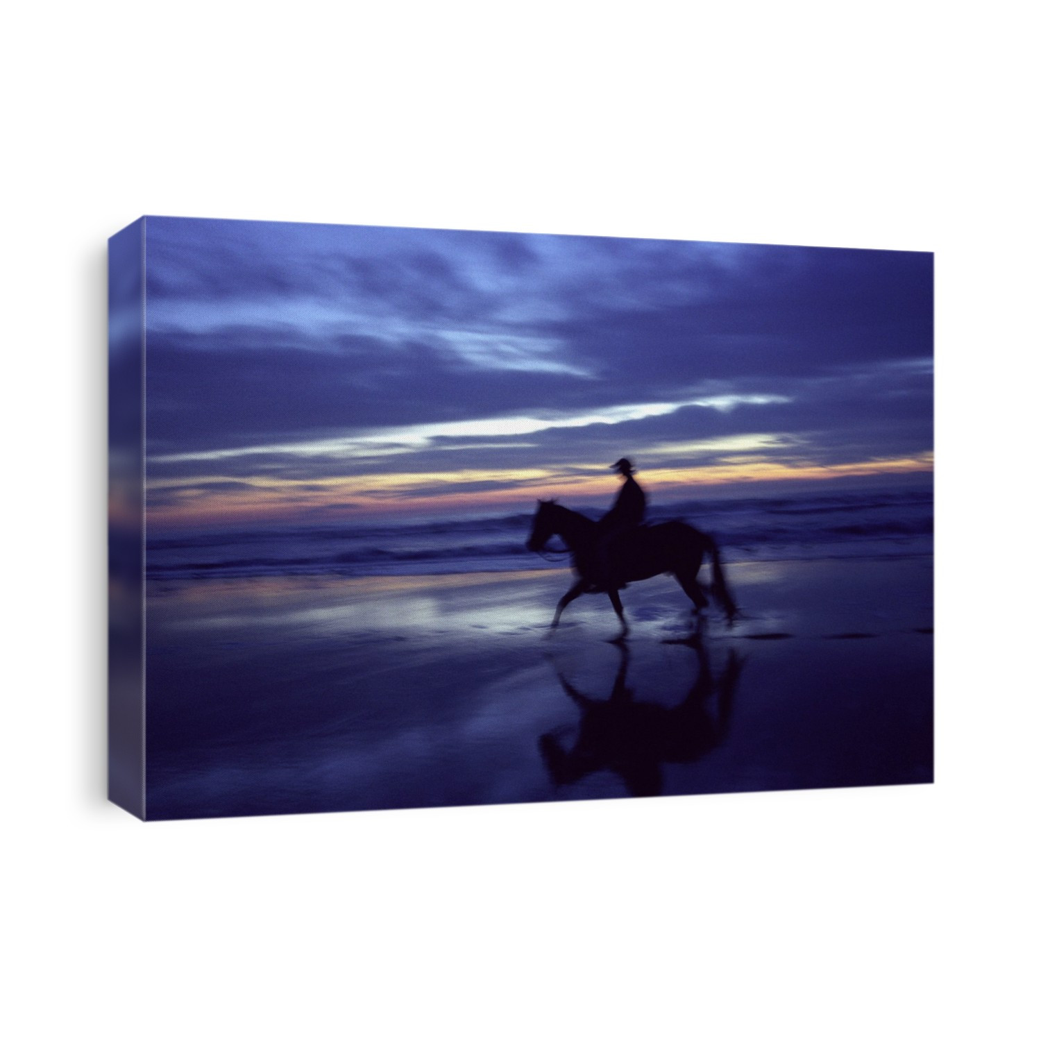 Horse riding. Blurred image of a person on horseback at twilight on a sandy beach.