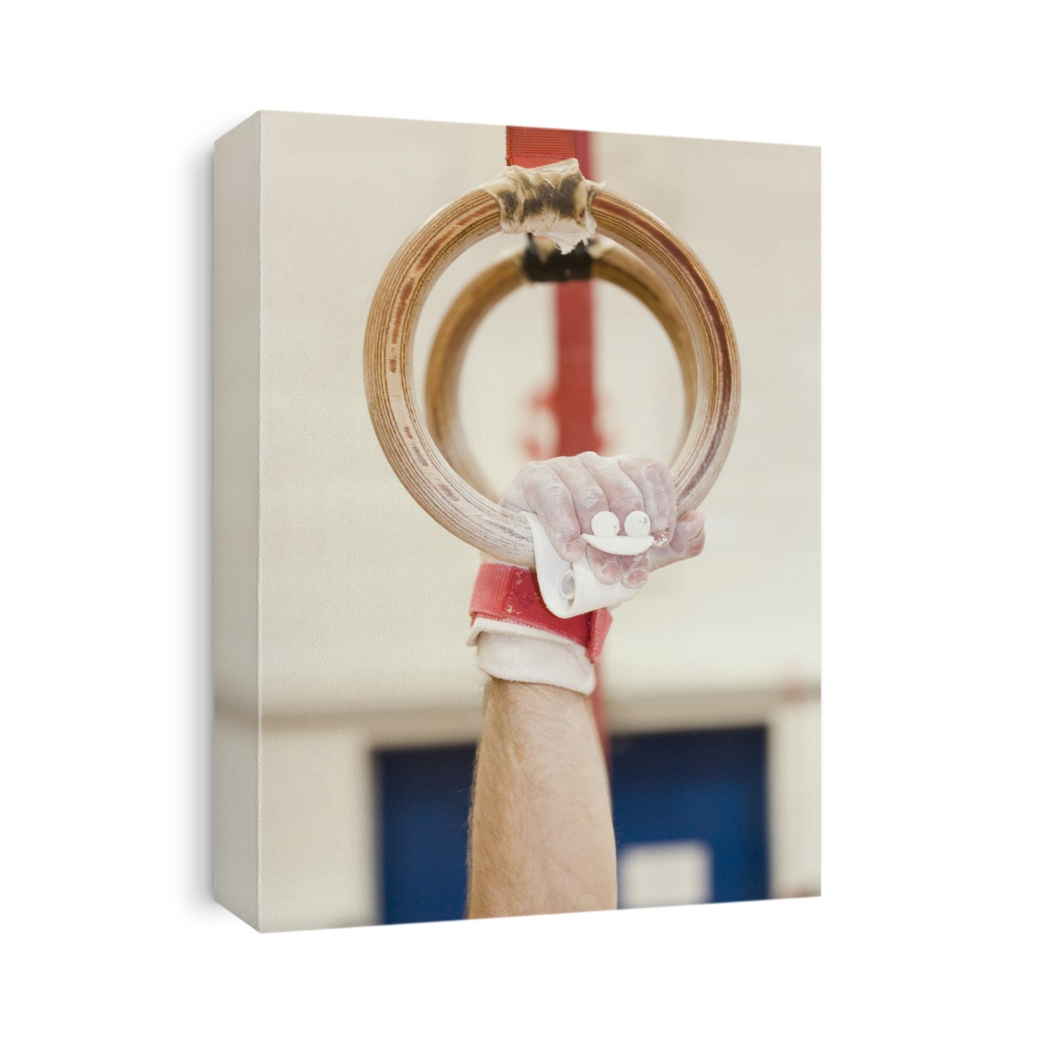 MODEL RELEASED. Gymnast gripping rings. This piece of gymnastic apparatus is used only by male gymnasts. The gymnast's hands and sometimes the rings are themselves are covered in white chalk to provide the grip needed to perform safely.