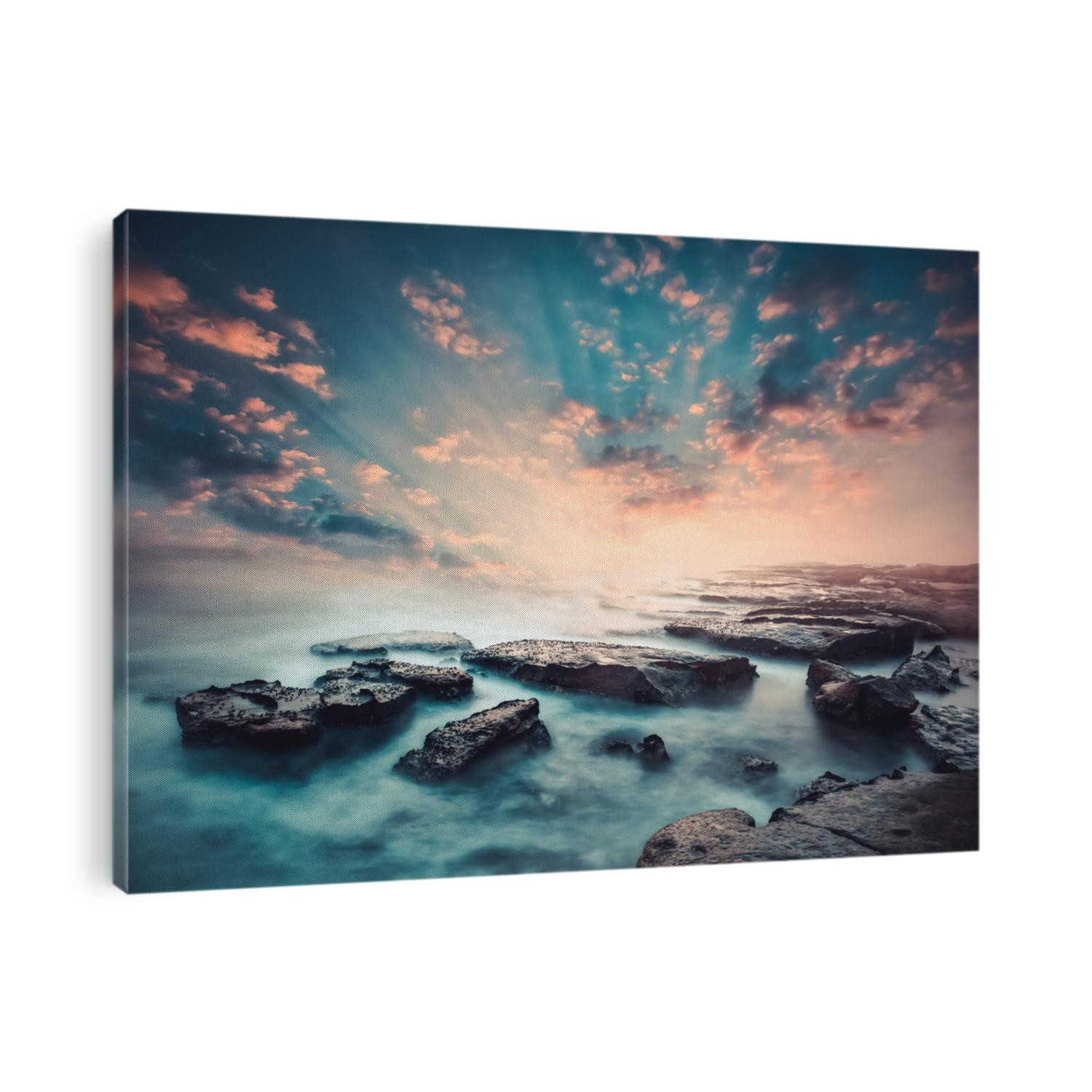 Sunset on the coast of the Sri Lanka at dawn with rocks in foreground