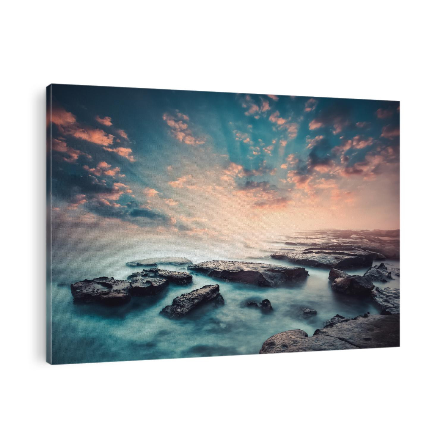 Sunset on the coast of the Sri Lanka at dawn with rocks in foreground