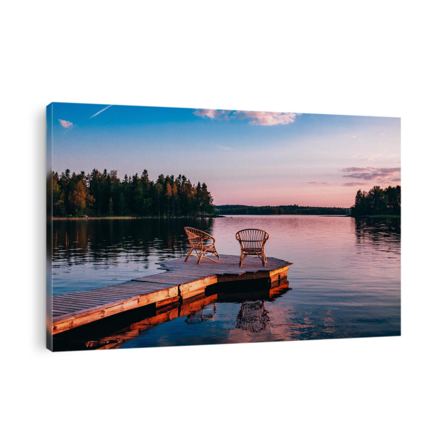 Two wooden chairs on a wood pier overlooking a lake at sunset in Finland