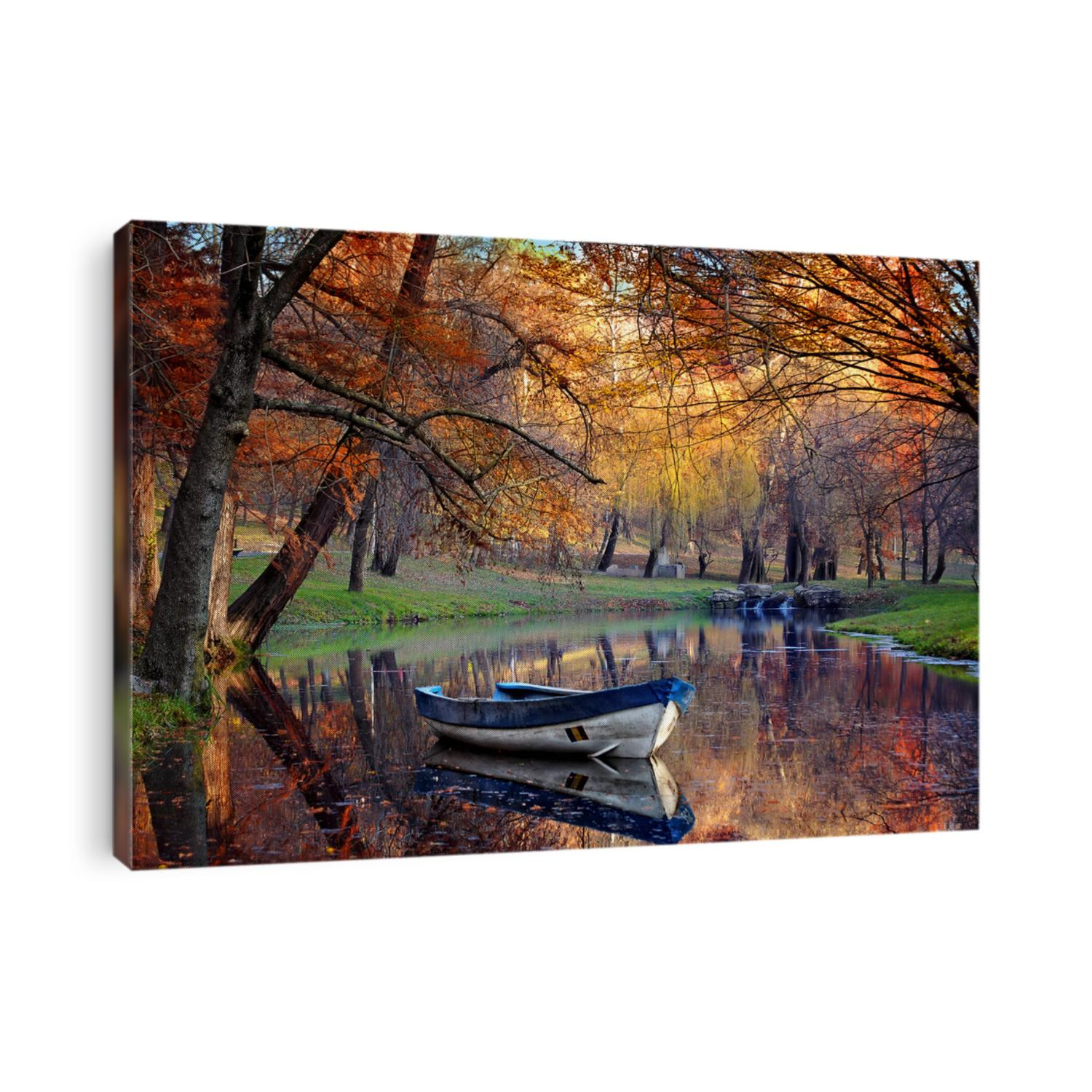 Colorful autumn landscape.Nature background.Boat on the lake in the autumnal forest