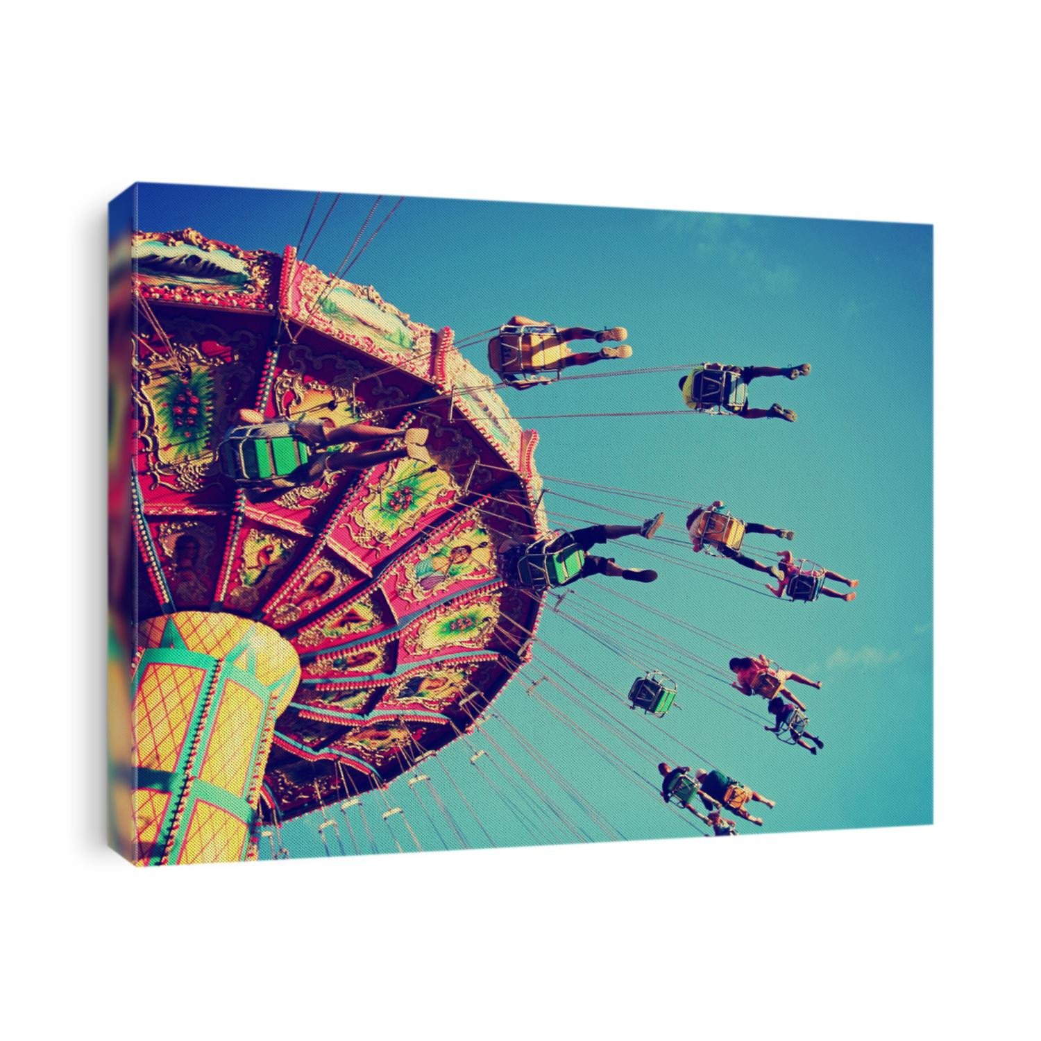  a swinging fair ride at dusk toned with a retro vintage instagram filter app or action