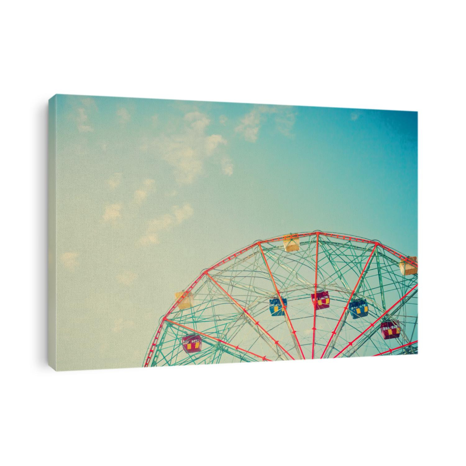 Vintage colorful ferris wheel over blue sky