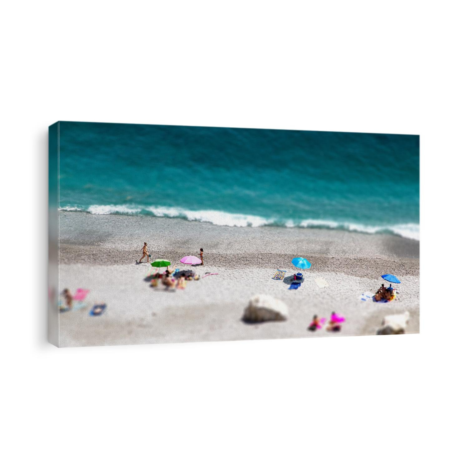 Tilt shift of Ocean beach view with beautiful waves of clean transparent water and white sand, high altitude view of beautiful seashore with sunbathe people, vacation and holiday concept, blur effect