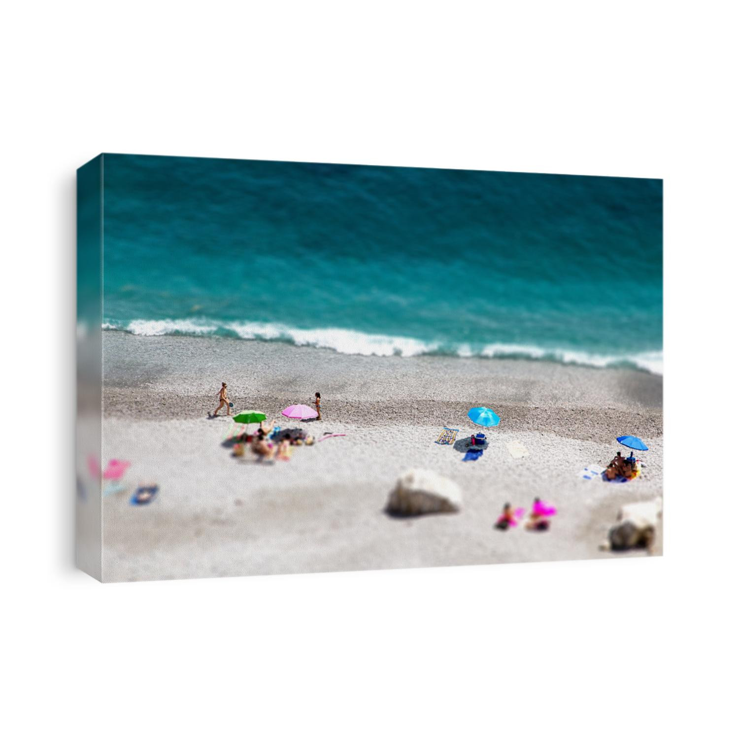 Tilt shift of Ocean beach view with beautiful waves of clean transparent water and white sand, high altitude view of beautiful seashore with sunbathe people, vacation and holiday concept, blur effect
