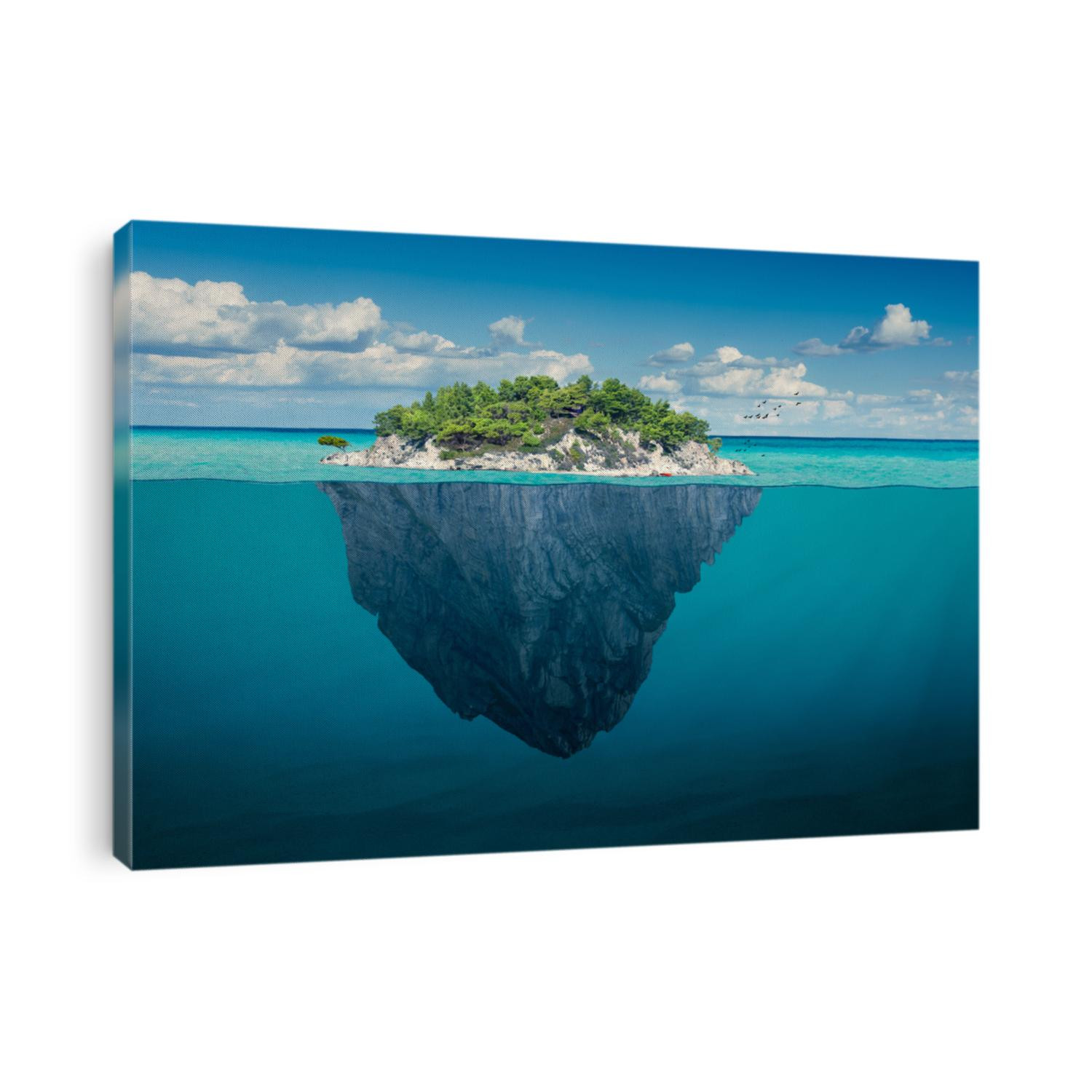 Beautiful underwater view of lone small island above and below the water surface in turquoise waters of tropical ocean.