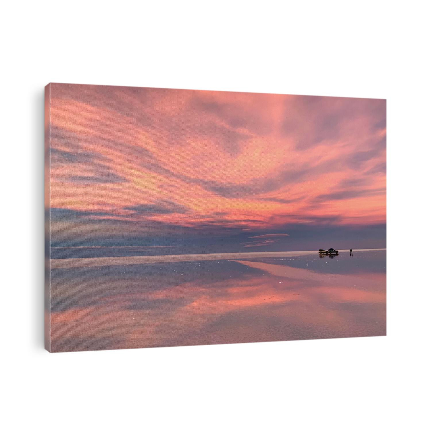 Beautiful Sunset over Salar de Uyuni Salt Flats in Bolivia. Spectacular colors sunset sky. Surreal magical desert landscape. Romantic pink sunset sky. Breathtaking view of sky reflection in salt lake
