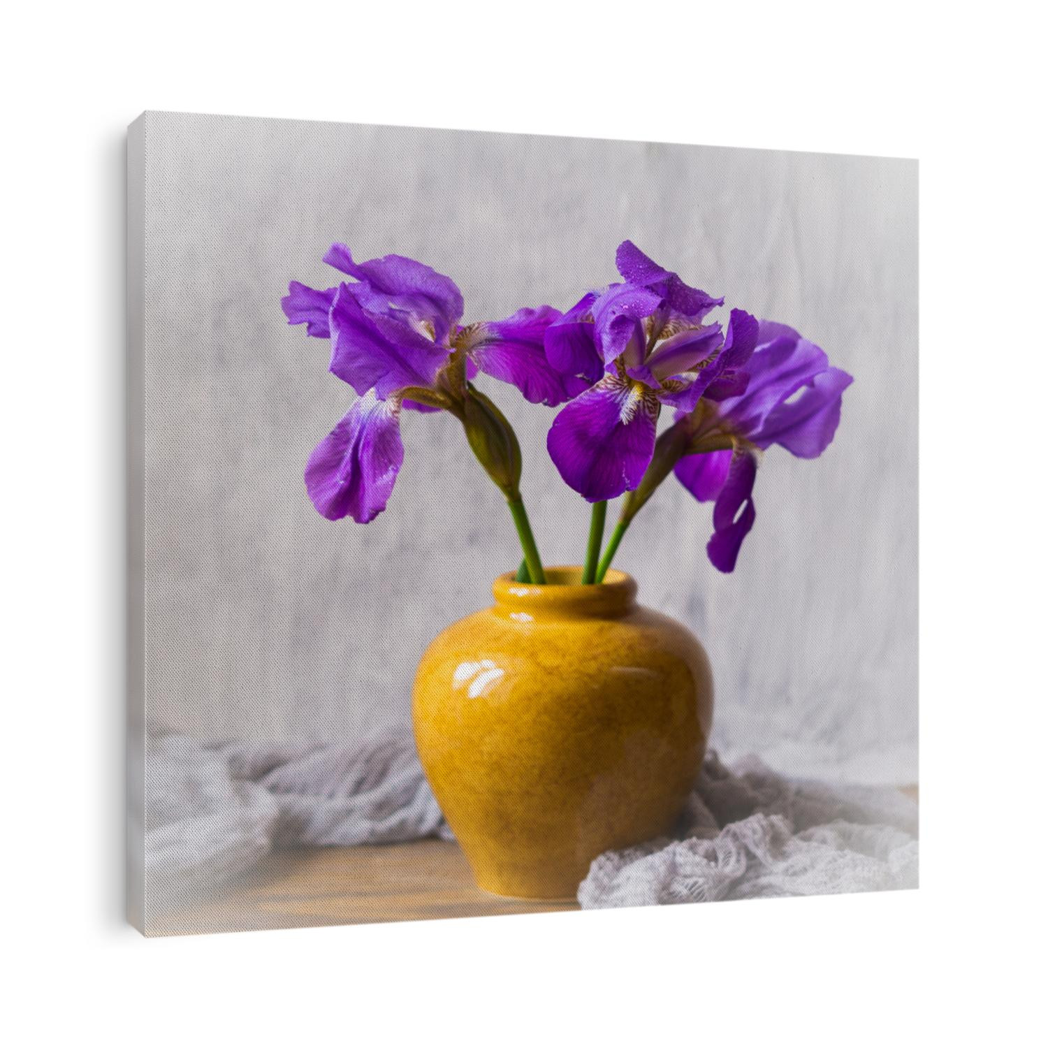 Fresh blue irises in a yellow vase. Still life with irises.