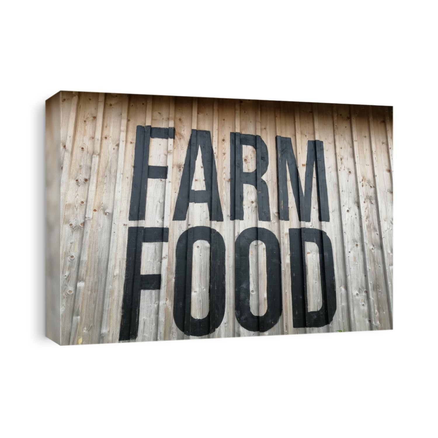 The words "farm food" written on a wooden wall. 
