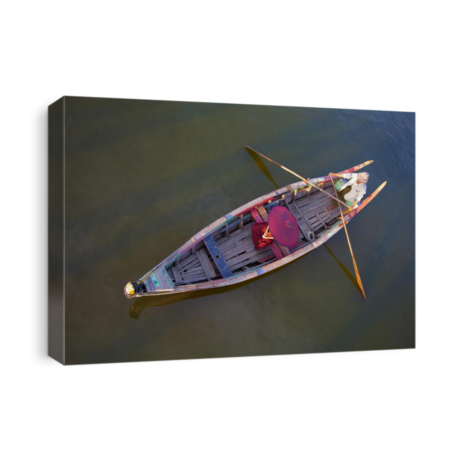 Burmese monk in longtail boat in Mandalay, Burma