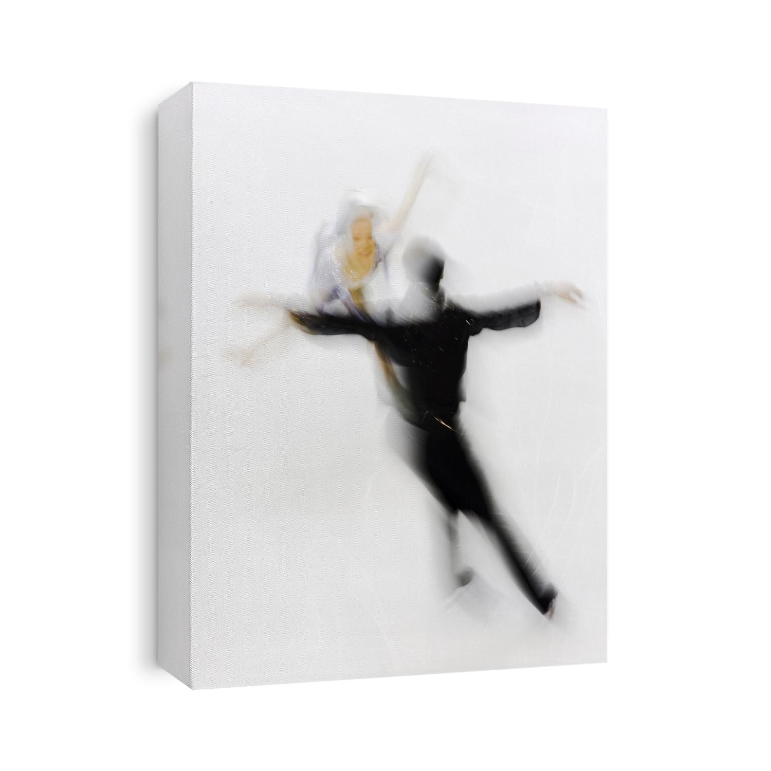 Blurred action of pairs figure skaters.