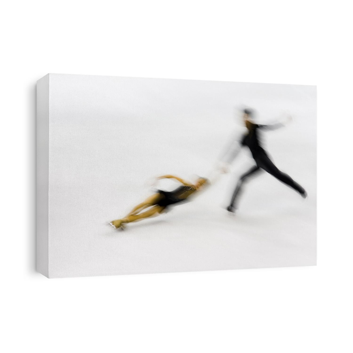 Blurred action of pairs figure skaters.