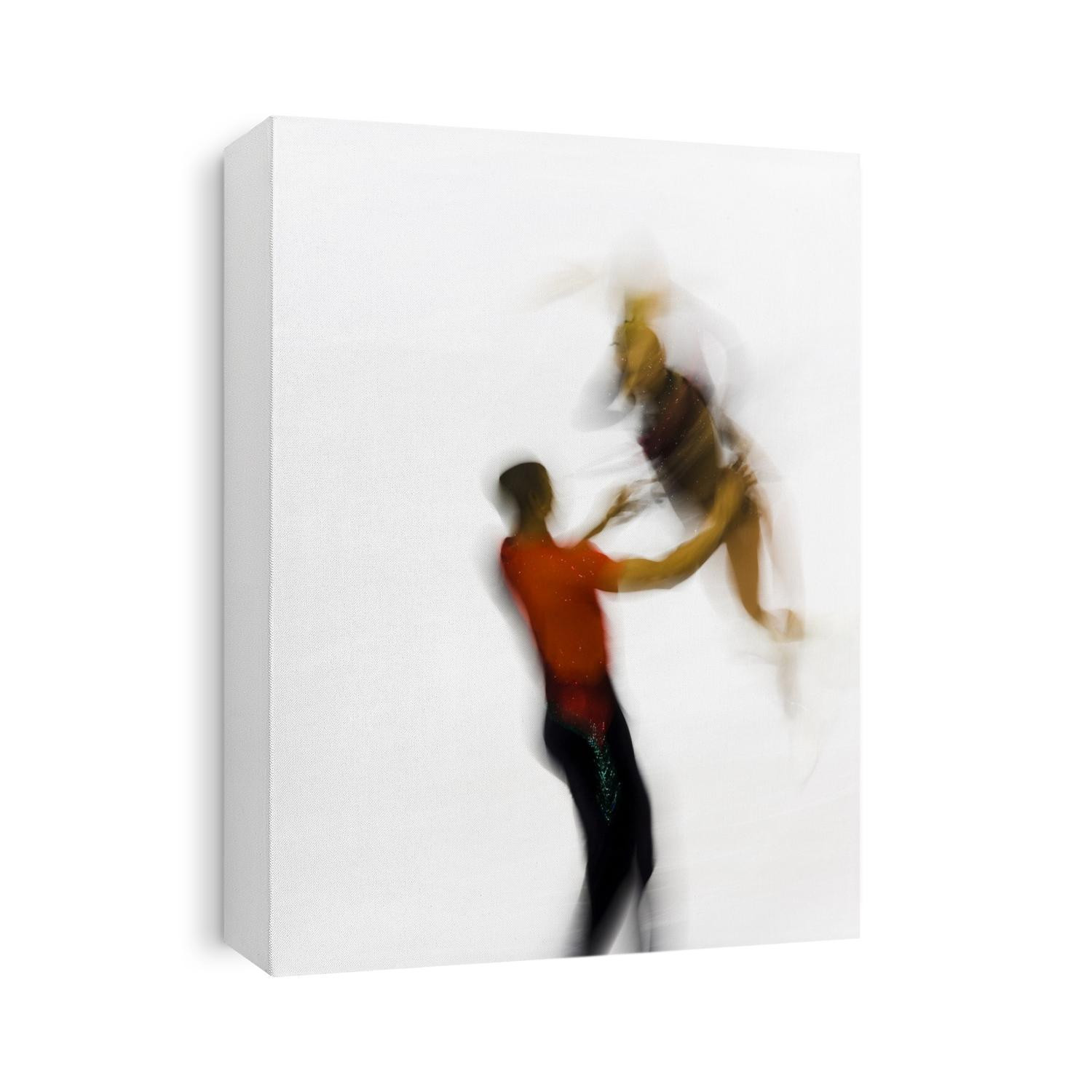 Blurred action of pairs figure skaters.
