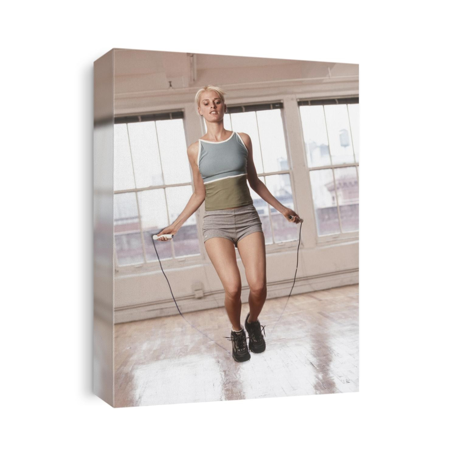 Women working out with jump rope in fitness studio.