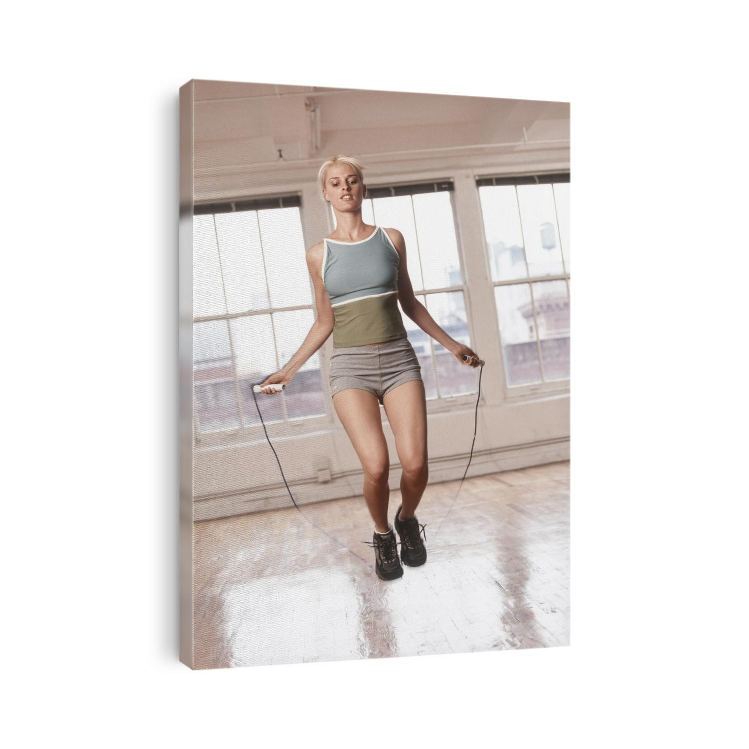 Women working out with jump rope in fitness studio.