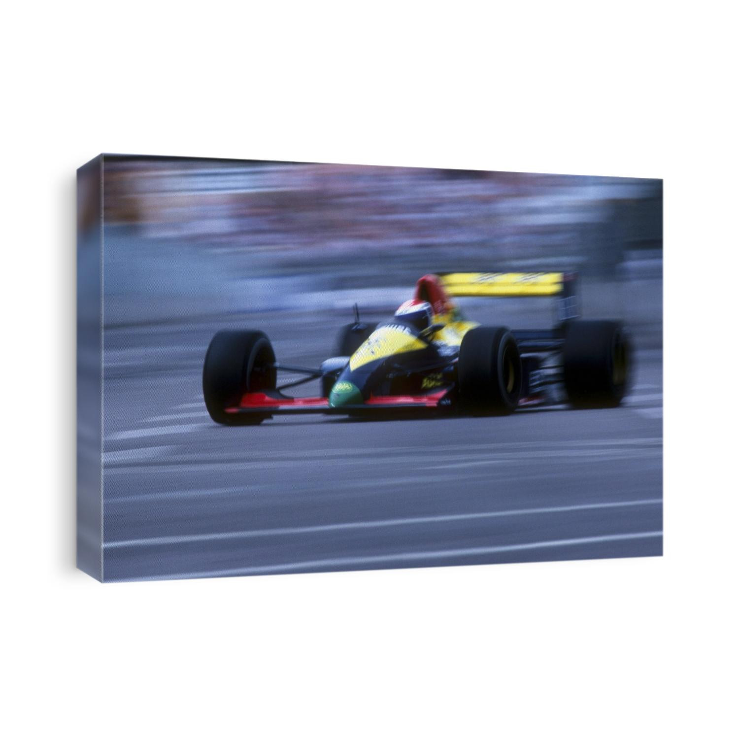 Blurred F1 auto racing action.