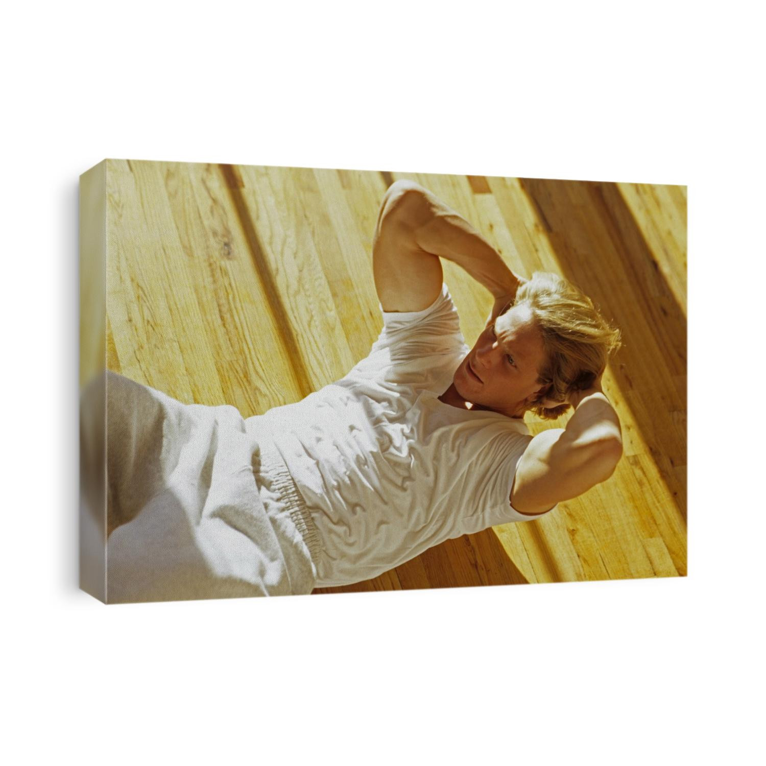 Man engaged in sit up exercise in gym