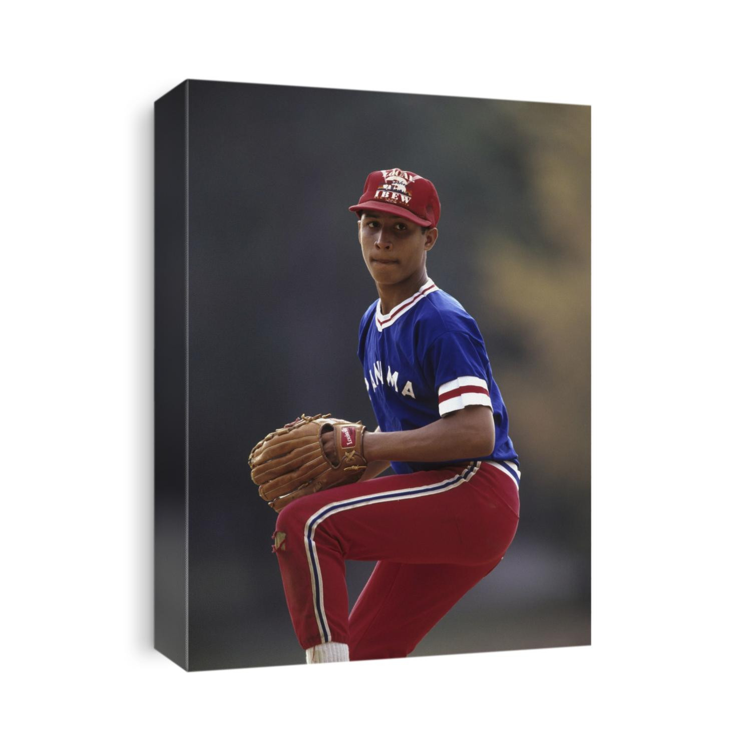 Young hispanic baseball pitcher in action.