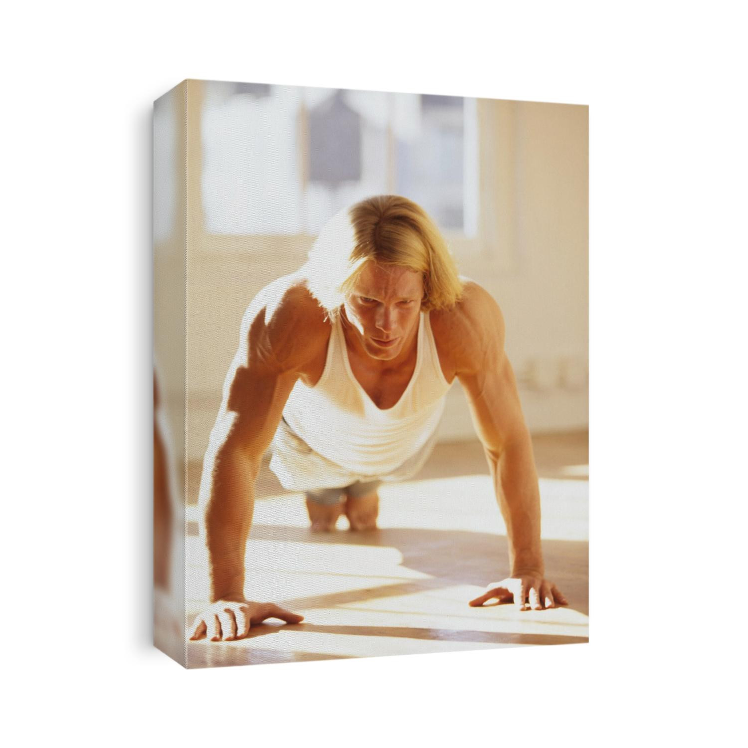 Young man preforming push up exercise in gym