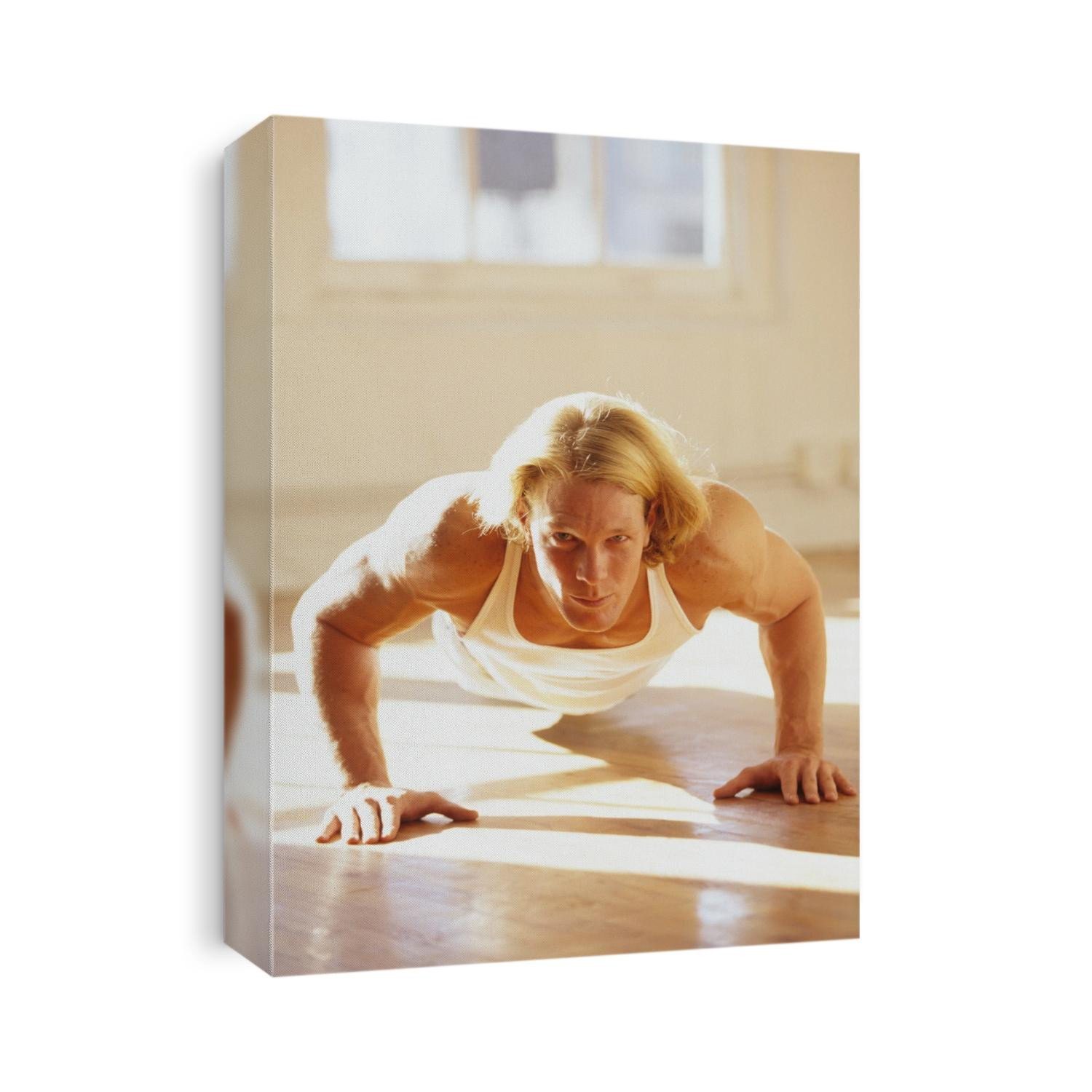 Young man preforming push up exercise in gym