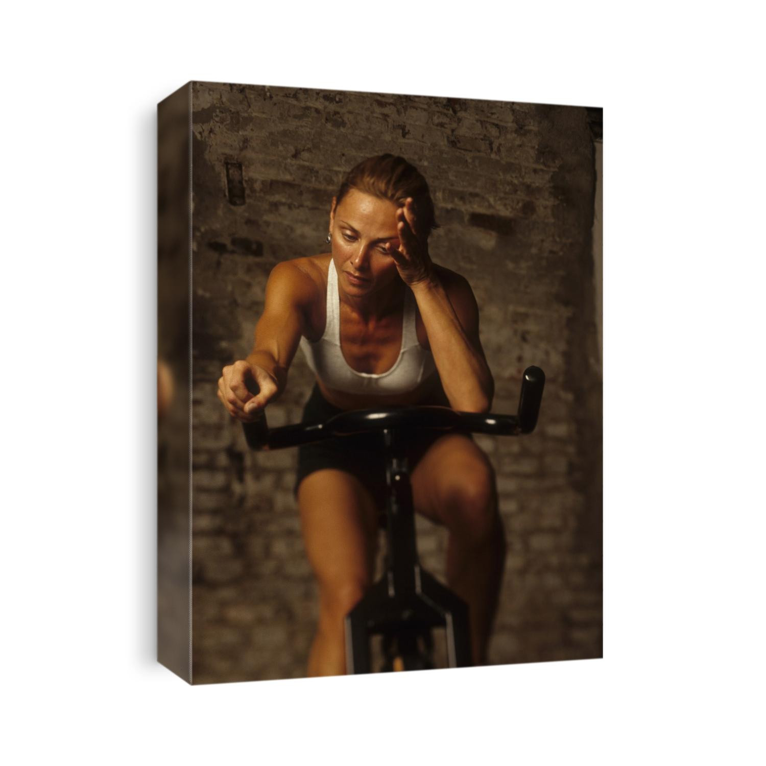 Young woman exercising on a stationary bike.