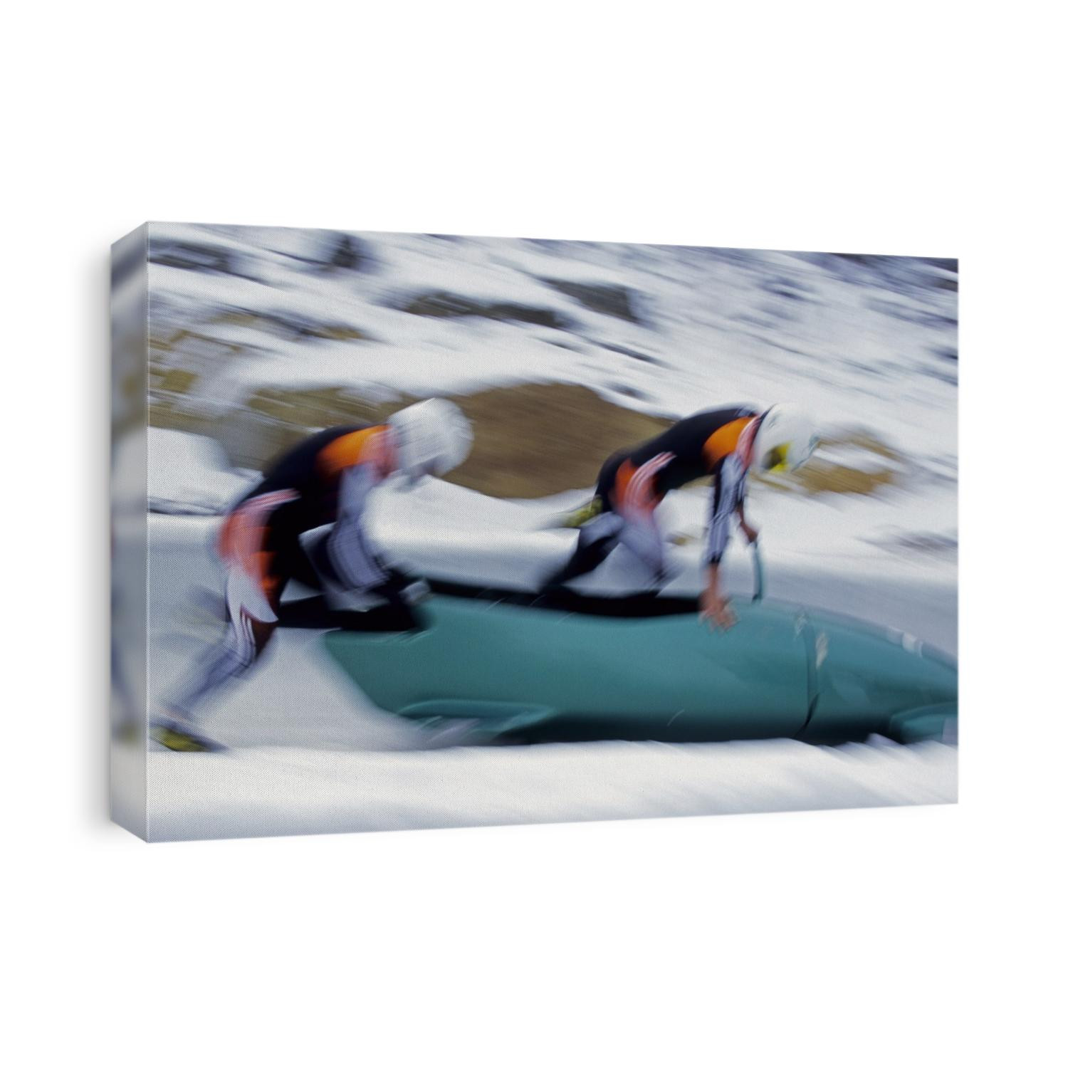 Two man bobsled team pushing off at the start.