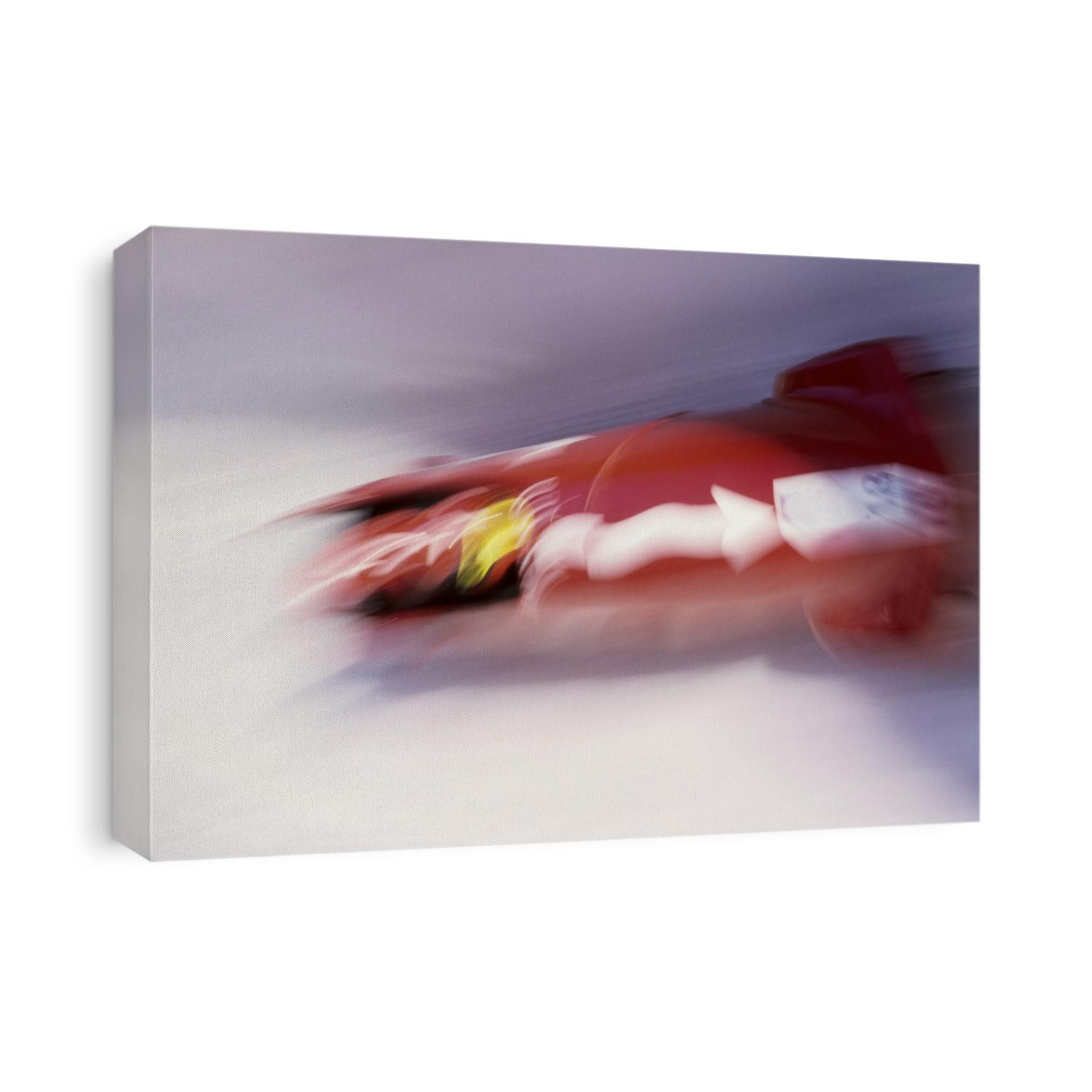 Blurred action of 4 man bobsled team.