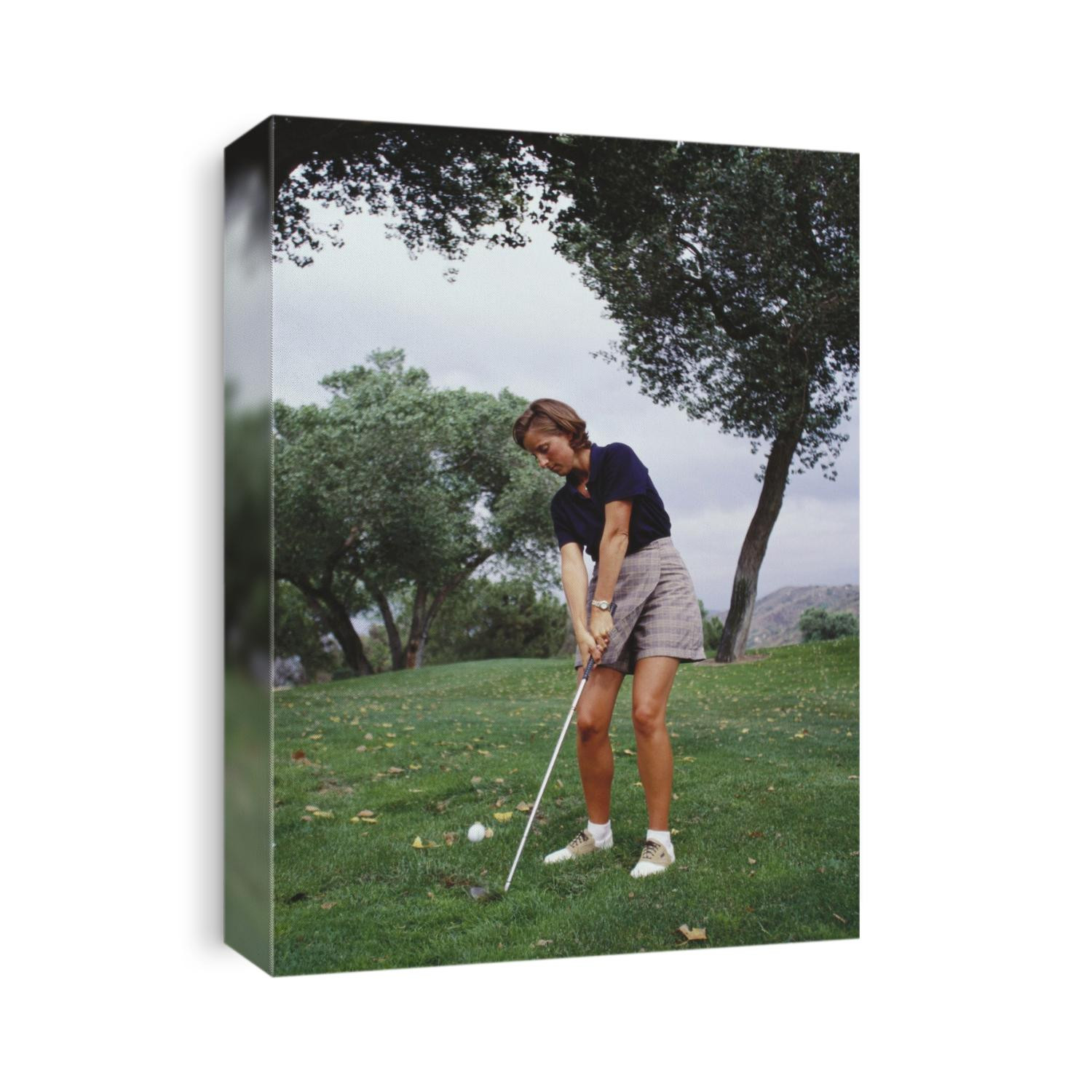 Woman golfer in action.