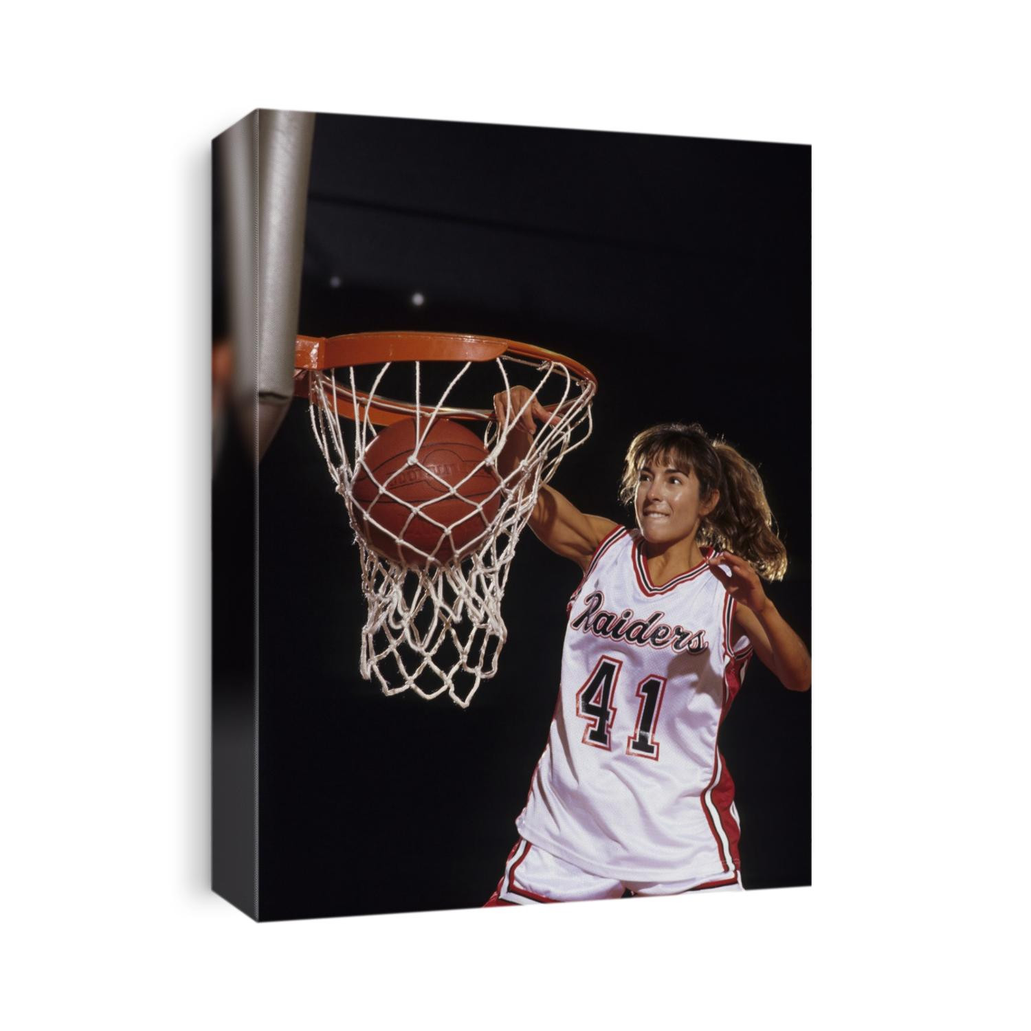 Female basketball player dunking a ball through the hoop,
