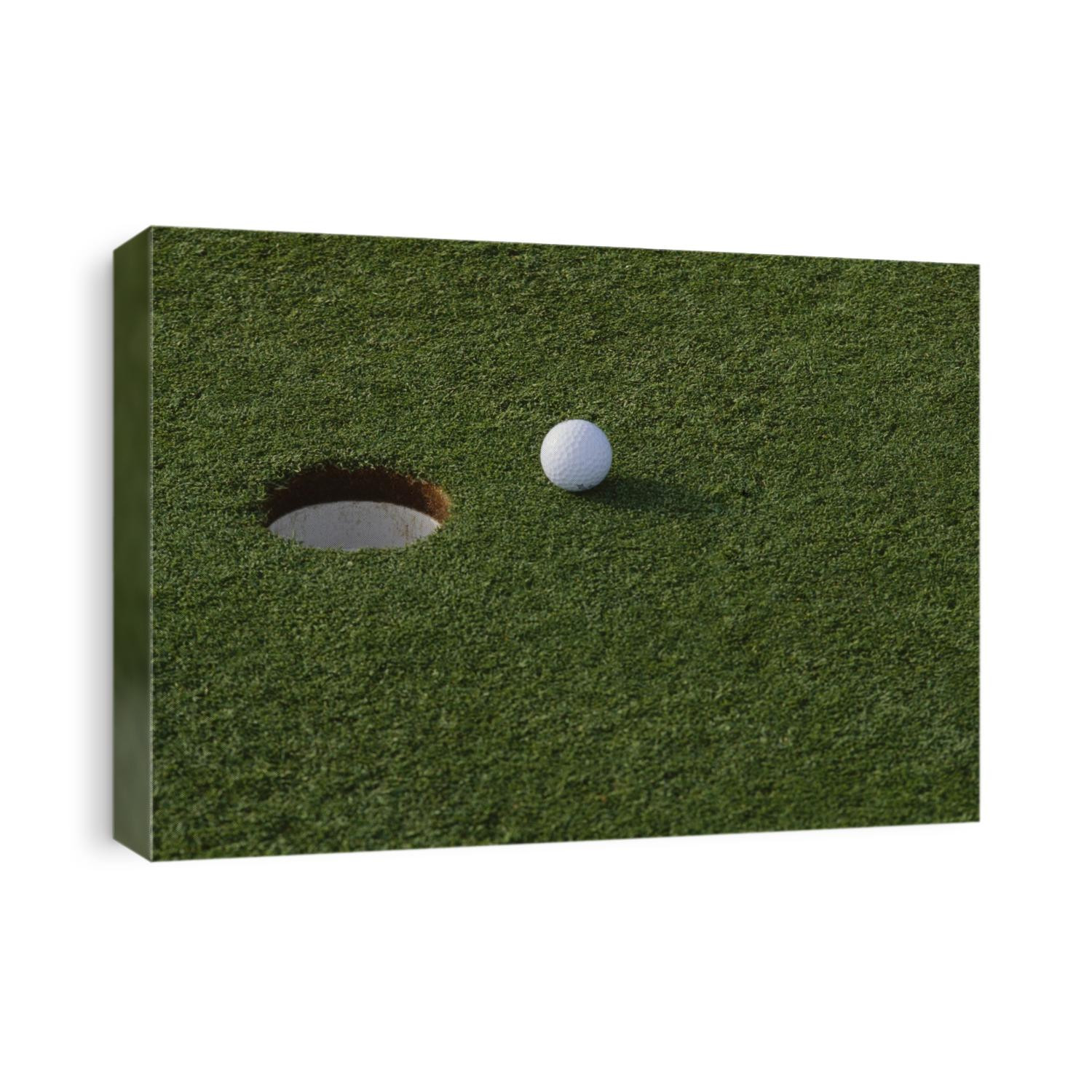 Golf ball at the hole.