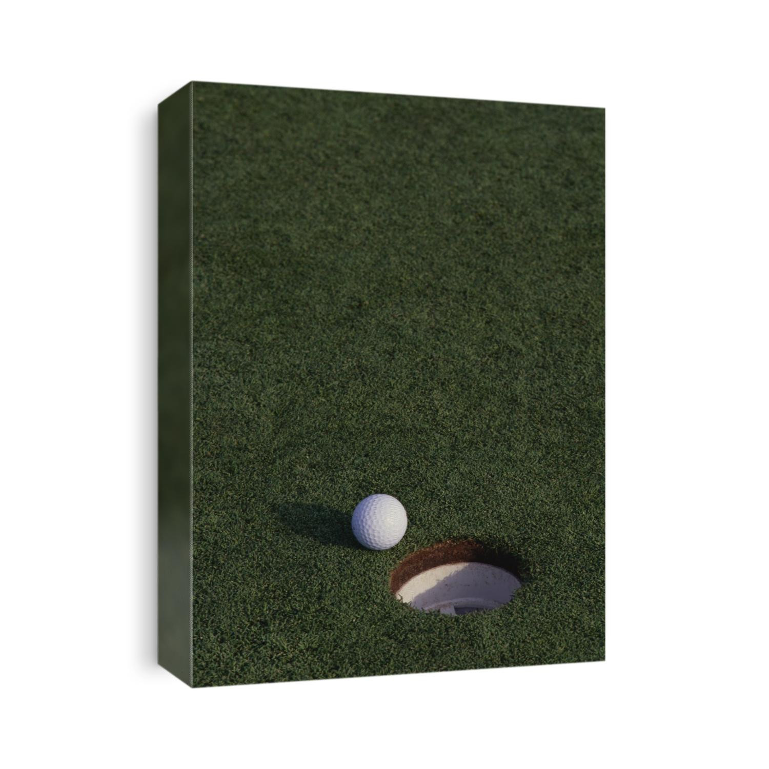 Golf ball at the hole.