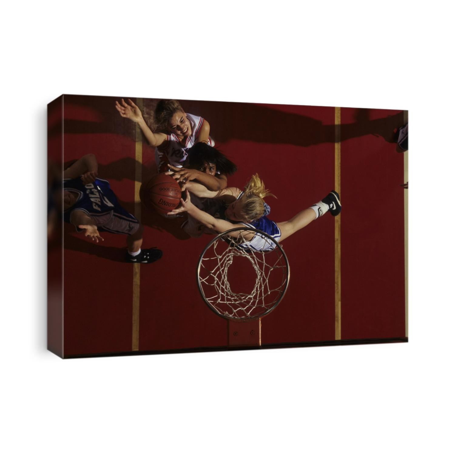 Teenage girs playing high school basketball.