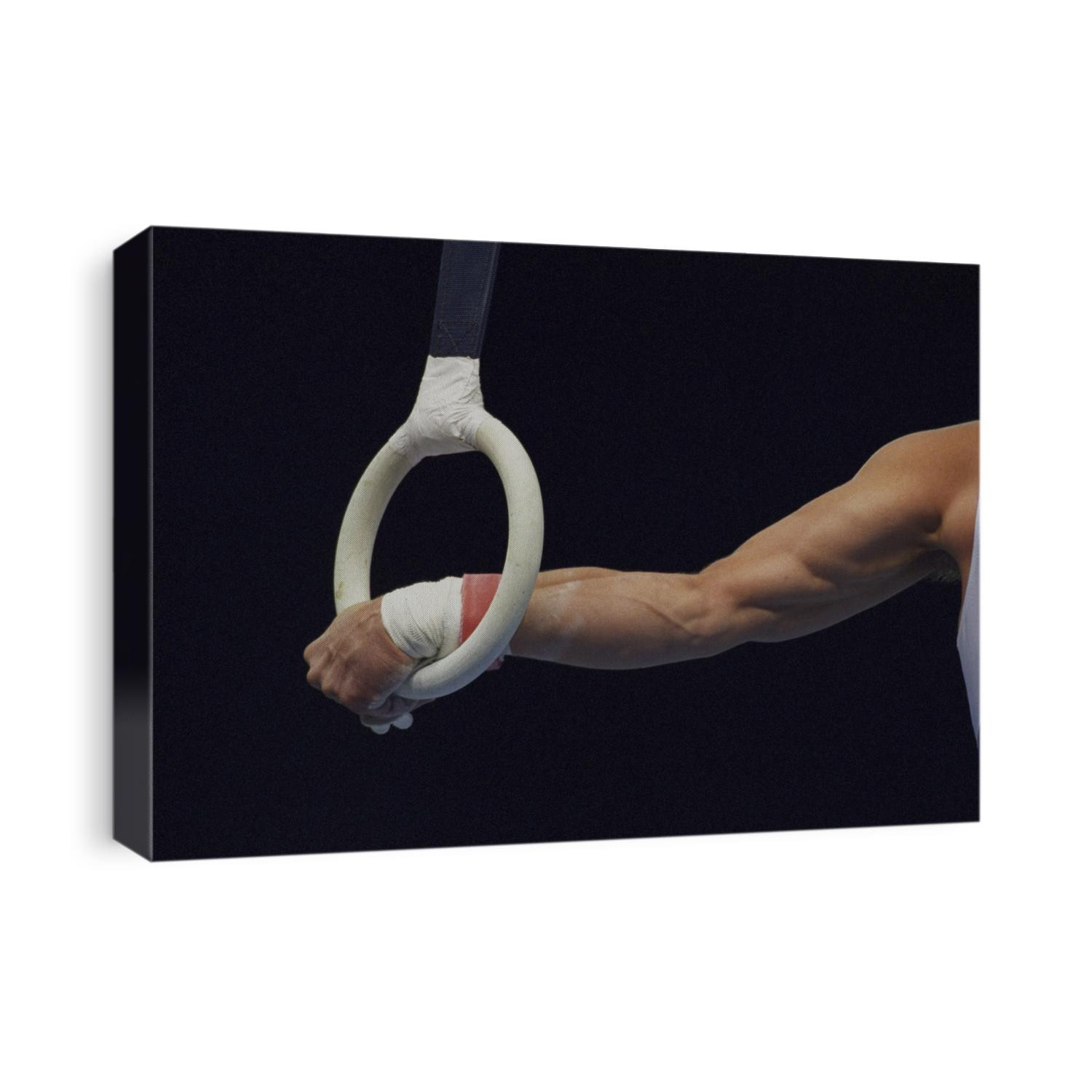 Detail of the hands of male gymnast grabing the ring